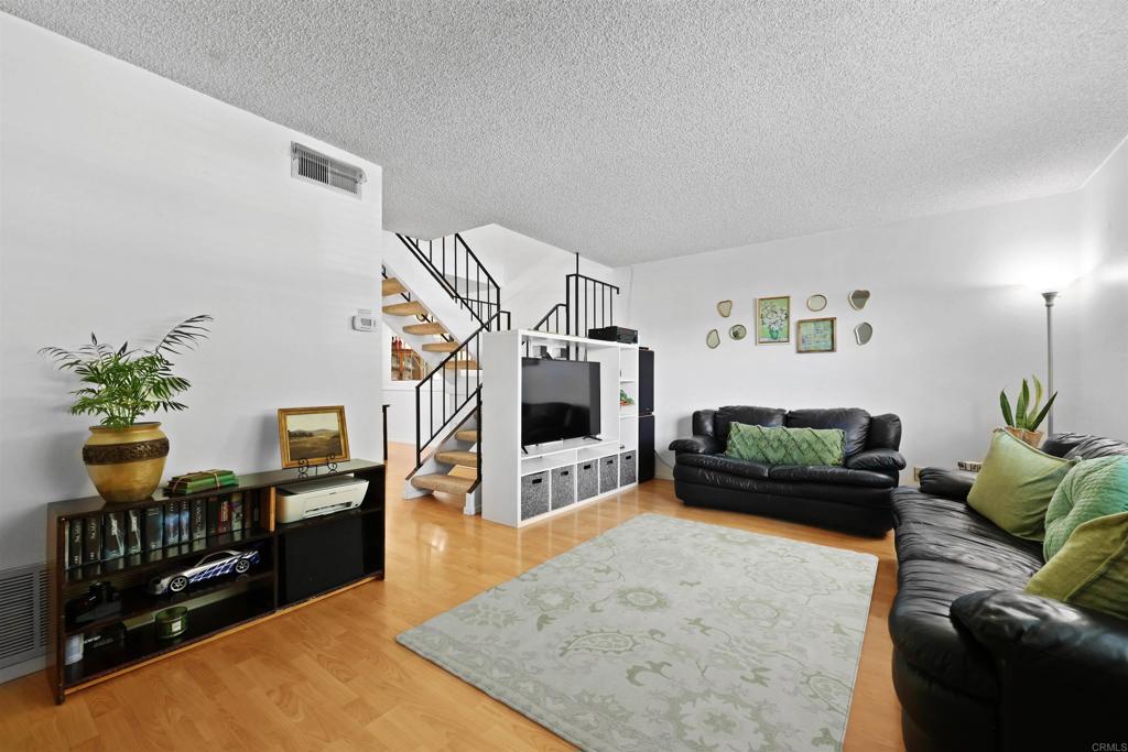 VA/FHA Approved. Seller will entertain offers between $545,900 to $565,900. Welcome to Royal Gardens, a serene community in the heart of El Cajon. This 3-bedroom, 1 full bath + 2 half bath condo lives like a townhome with its spacious two-level layout, private patio, and thoughtful interior updates. The interior features all bedrooms located upstairs, each with cozy carpeting and generous natural light. Main level features laminate wood flooring, a comfortable living area, and a dedicated dining space. Modern kitchen with quartz-style counters, sleek white cabinetry, tile backsplash, and black appliances. In-unit laundry room with built-in shelving for added storage and convenience. One full bathroom upstairs, plus two half baths (one on each floor) for maximum functionality. Private, fenced patio with covered area and plenty of space for BBQs or gardening. Community Amenities Resort-style swimming pool with lounge chairs and shaded sitting areas. Playground with play structure, picnic tables, and safe gated access. Beautiful landscaping and secure, well-maintained common areas. Assigned parking with additional guest spaces available. This condo offers the comfort and space of a townhome with the ease of condo living—perfect for families, first-time buyers, or investors. Located close to shopping, dining, freeway access, and schools, it's a rare opportunity in a desirable community.