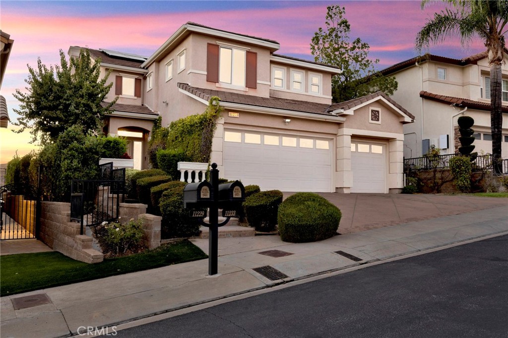 Unrivaled Views – Sorrento Living at Its Finest. DO THE COMPARISON! Unmatched value in the exclusive, guard-gated Sorrento community of Porter Ranch with sweeping city views. Elegant two story home, manicured landscaping and a serene sunset backdrop. 2,709 square feet of elegant & bright living space featuring striking curved staircase with wooden banister. The two story foyer highlights the beautiful chandelier and tiled flooring with decorative inlays. The walls are painted a warm, light yellow, complemented by custom white crown moldings. Adjacent to the living room is the dining section and a family room that seamlessly flows into a gourmet kitchen with granite counter tops, light wood cabinetry, large center island, custom backsplash and built in appliances like fridge, stainless steel double oven, cooktop, and dishwasher. Abundance of windows plus sliding door leads to the backyard from the family room to a resort backyard + paved patio area under a pergola supported by columns. An inviting spa among decorative rocks and unbelievable sunsets! First floor includes 1 bedroom, 1 full bathroom and a separate room for laundry adjacent to a direct access three car garage. Ascend to the second floor and you will find 5 bedrooms and 2 bathrooms. Spacious second floor landing is bathed in natural light from well placed high custom windows, natural toned carpet and expansive transition to the bedrooms and the private primary suite. 3 spacious bedrooms and a primary bedroom. The primary suite is the highlight of this home, the major highlight is the direct access to the private terrace with views of the hills and city. Views all the way to Santa Monica mountains, Santa Susana mountain, and the entire the valley. The primary en suite bathroom features tiled walk in shower and deep soaking tub with a perfect window placement to absorb in all the views. The dual sink vanity with ample counter space highlighted by two ornate, matching mirrors and stylish sconce lighting. Also not to forget the generous walk in closet ensuring a high end primary suite experience.
Additional property feature includes solar panels. The home is in a desirable 24-hour guard-gated community with a TWO community pool/spa with low HOA dues of $305 per month. Come experience the difference in Porter Ranch.