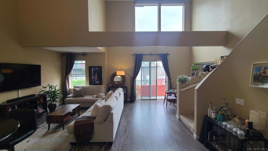 One of a Kind Condo in Little Italy! This unique unit located at the Village Walk on the 5th floor, unfurnished $3750.00 spacious living, loft style 2 story condo, 1 primary bedroom ensuite, plus 2nd full bath, in the heart of San Diego’s Little Italy! With 26'ft ceilings, open living & dining area with beautiful wood flooring, opens up to a balcony facing India Street, partial views of the bay, city lights and the star of India. Unit offers a full kitchen with built in appliances, gas stove top range, oven, dishwasher, disposal, microwave, refrigerator, large walk in pantry, tile flooring, granite counters, bar style seating, and in unit laundry. Special feature of 2 areas/spaces on the first floor that can be used for a full-size home office and/or additional dining perfect for entertaining! Includes 1 garage assigned parking space; trash & recycle, garage storage unit, Village Walk communal space with kitchen, gym and several communal spaces in and around the courtyard.Tenant responsible for all utilities and renters insurance.