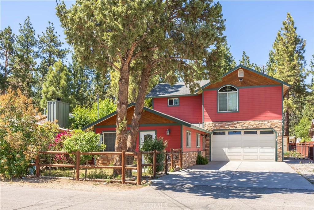 Nestled in the charming mountain community of Big Bear City, 209 West Meadow Lane offers a remarkable opportunity to own a spacious haven, whether you're seeking a full-time residence or a vacation retreat. This home provides an exceptional value with its enticing blend of comfort and utility. Spread across 1,625 square feet, the home features three inviting bedrooms and two well-appointed bathrooms. The vaulted ceiling in the owner's suite enhances the sense of space, creating a serene retreat. A great wood-burning stove takes center stage in the living area, perfect for cozy evenings after a day of mountain adventures. The property boasts a rare attached two-car garage, a sought-after feature that adds convenience and storage space. The 5,500-square-foot lot provides plenty of yard space, including a large low-maintenance backyard for outdoor enjoyment, gardening, or simply soaking in the serene mountain surroundings. Year-round comfort is assured with air conditioning and an included washer and dryer unit, making this home as practical as it is charming. The combination of amenities and mountain style makes it a wonderful investment for those looking to maximize lifestyle and value. With its idyllic setting and thoughtful features, this property truly offers a lot of home for the money, ready to welcome you to mountain living at its finest.