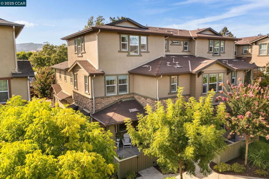 Welcome to Walden Park Commons, a lushly landscaped community just moments from BART, Iron Horse Trail, parks, and top-rated Walnut Creek schools. This rare corner unit is the largest floor plan in the community, offering three levels of thoughtful living space. Step through the gate into your own private front patio — a perfect spot for morning coffee or evening gatherings. Inside, a light-filled family room with custom shutters flows seamlessly into the dining area and kitchen, featuring stainless steel appliances, a walk-in pantry, breakfast bar, and plentiful storage. Interior access to the attached two-car garage with custom cabinetry and EV-ready outlet adds everyday convenience. Upstairs, the spacious primary suite boasts a walk-in closet, dual vanity, soaking tub, and step-in shower. Two additional bedrooms, a full bath, and a laundry room on the same level make daily living effortless. The third level offers additional flexible space, with its own dedicated AC zone — one of three separate zones (one per floor), ensuring comfort year-round. The Walden Park community is known for its lush courtyards, pool, clubhouse, and beautifully maintained grounds, creating a serene retreat in the heart of Walnut Creek.