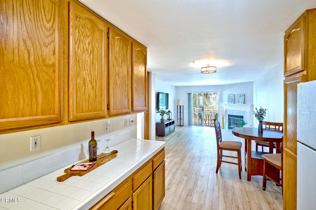 This upgraded 2 bedroom 2 full bathroom Vista Camarillo condo is move-in ready offering city and mountain views. The open floor plan has a light and spacious living room that features a fireplace and opens to a private patio - perfect for enjoying morning coffee or relaxing in the evening The kitchen includes all white appliances and the wood-like laminate flooring throughout creates a fresh, contemporary feel.The primary suite offers an en-suite bathroom for comfort and privacy. The versatile second bedroom works perfectly as a home office, guest space or workout room. A private laundry room is located just outside the entry and provides extra storage space and this condo is one that includes your own private detached 2-car garage.As a resident of Vista Camarillo you will enjoy the amenities of a pool, spa, clubhouse, two RV storage lots, a tennis court, basketball court, car wash area and views. Water, sewer, trash is also included with the HOA. Conveniently located near Camarillo Premium Outlets, public library, dining, parks, medical facilities, coastal beaches and freeway access. This community is also FHA and VA approved. Whether you're a first-time buyer, downsizing or investing, this home offers comfort and convenience.