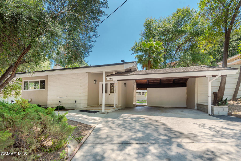 Highly desirable custom single story home located south of the boulevard in one of Woodland Hills premier neighborhoods! This custom 3+2 home features freshly painted interior & exterior, lots of double paned Milgard windows for natural light and laminate wood-like plank & refinished parquet wood flooring throughout. Beautifully remodeled bathrooms. Double front door entry with large foyer area. Oversize kitchen with white tile counters, lots of cabinets, stainless steel appliances including double oven and separate area for additional kitchen prepping,storage, sewing corner, etc. Kitchen opens to large family room. Huge living room with beautiful open beam vaulted ceilings, gas white brick fireplace and separate formal dining room area. Large primary bedroom with lots of windows for views of backyard, walk in closet with built in organizer and beautifully remodeled ensuite bathroom includes marble-like tile shower/tub enclosure, wood vanity with white stone countertop and new hardware & fixtures. Nice size secondary bedrooms and a beautifully remodeled jack&jill bathroom which features marble-like tile flooring, white vanity with marble countertop and large shower with marble/like tile & glass enclosure and new hardware and fixtures. Indoor laundry area and lots of hall storage cabinets. Peaceful private backyard with large concrete area and neatly landscaped. Gated side entrance to large grassy turf area and ample space for parking. Oversize insulated shed included. 2 car covered carport with large storage cabinet. Tankless water heater. One of a kind custom home. Come make it yours!