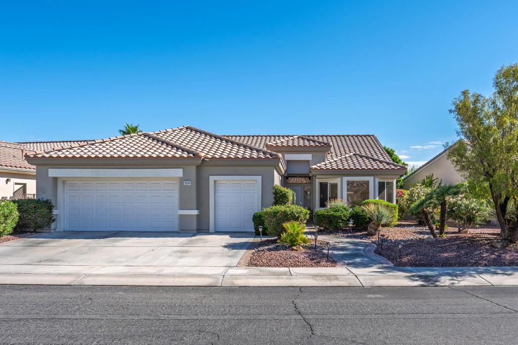 Sun City Palm Desert - St. Croix. This sought-after floorplan features 2 bedrooms, 2 bathrooms, a den, hobby/bonus room, and a 2-car plus golf cart garage. The north-facing rear yard offers privacy with no homes flush behind, lush desert landscaping including citrus, peekaboo mountain views, and an expanded patio for outdoor living. Curb appeal is enhanced by an updated paint scheme and leaded-glass entry door. Inside, 19-inch tile flooring runs throughout the main living areas, while the bedrooms feature vinyl plank. Upgraded baseboards and extensive crown molding add a refined touch. The greatroom boasts an upgraded slider and windows framing the rear yard. Double doors lead to a den with custom built-ins, while a pocket door opens to the hobby/bonus room, also equipped with built-in desk and shelving. The kitchen showcases abundant cabinetry with pullout shelves, a chef's island, breakfast bar, stainless appliances including double wall ovens, slab granite counters, tile backsplash, and upgraded fixtures. The primary suite offers a spacious retreat with custom built-in cabinetry, media center, shutters and a walk-in closet with built-in storage. Its spa-like bath includes a floating vanity with granite counter, upgraded dual sinks, lighting, and a custom tile shower with rimless glass enclosure. The guest bath is equally upgraded with a floating granite vanity, modern fixtures, and a tub/shower with glass enclosure. The laundry room provides ample cabinetry, granite counters, and a utility sink. Completing the home is a 2+ car garage with golf cart space and abundant storage.