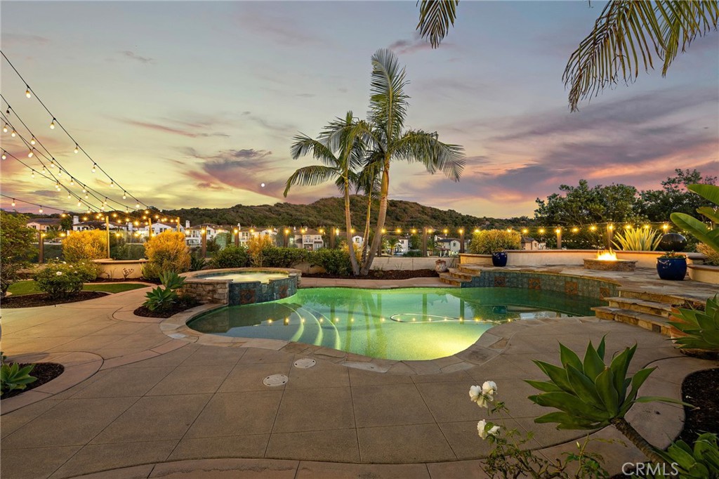 Sensational PANORAMIC & OCEAN VIEWS, immaculate finishes and a peaceful end of cul-de-sac location sets the stage for this amazing beauty that you've been waiting to call home! Perfectly placed in the sought after gated "Catania" neighborhood in Talega and displaying an impressive curb appeal, it greets you with a beautifully landscaped front yard which immediately draws you in. Upon entry you will immediately feel the warmth that surrounds this approximately 3547 square foot property which is elevated in style and designer finishes. This exceptional 5 Bedroom (MAIN FLOOR BEDROOM CURRENTLY USED AS AN OFFICE), BONUS ROOM, 4 bath home offers the perfect blend of luxurious entertaining space, serene privacy and modern comfort. Inside you will see that the main level living flows seamlessly to the next, creating a welcoming & inviting ambiance starting with the jaw dropping conversation room with a stunning wood feature wall and beamed ceiling. The heart of this stunning property is the chef-inspired kitchen which offers two islands with bar seating, high-end stainless appliances, an abundance of pristine, white cabinetry and breakfast nook. Just off the kitchen is the family room with custom built ins and stylish fireplace with custom wood mantle. The over-sized dining room is the perfect setting to host family gatherings. MAIN FLOOR BEDROOM is currently customized as a home office with tranquil views of the backyard and conveniently located near the remodeled hall bath with walk-in shower. Upper level is host to the restful proportions of the four private retreats or hang out in the BONUS ROOM w/ custom built-in. One ensuite bedroom - 2 secondary bedrooms share a jack & jill bath. Outshining them all, the primary suite showcases a spacious walk-in closet and a luxurious ensuite with dual vanities, walk-in shower, soaking tub, & private balcony. Endless hours will be spent outside enjoying your resort-inspired, wraparound complete w/pool, spa, Fire Pit, BBQ Island, Fireplace, & perfectly manicured grounds. ENHANCEMENTS TO APPRECIATE: European White Oak Wood Floors, Solar, Water Filtration, House Re-Pipe. In addition, you will get to take advantage of all of the wonderful amenities in Talega! Don't let this one pass you by ... come for a tour before it's gone!