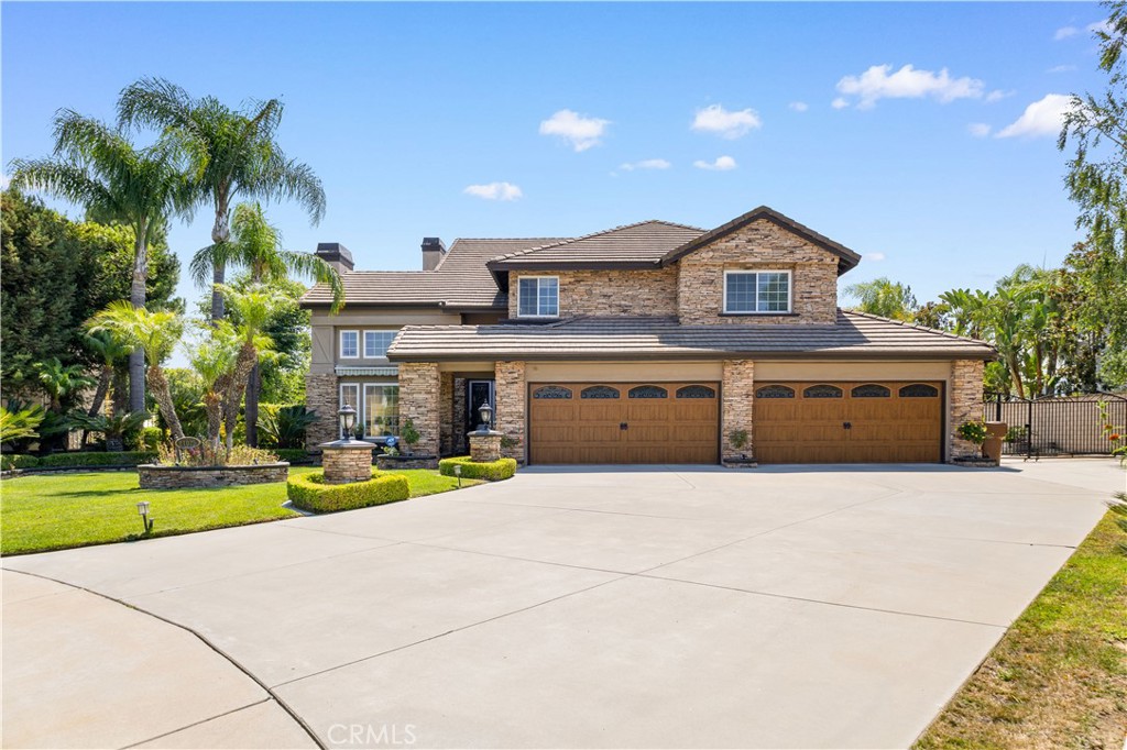 Perched atop a hill in Yorba Linda, this extraordinary home offers panoramic valley views and timeless elegance. From the moment you step inside, you’ll be captivated—professionally designed interiors exude sophistication, while the exterior is beautifully finished with stacked stone for lasting curb appeal.
The spacious family room, complete with a wet bar, seamlessly flows into the gourmet kitchen featuring a center island, breakfast nook, and expansive picture windows framing the scenic surroundings. A downstairs game room offers versatility and can easily be converted into a fifth bedroom.
Upstairs, discover four bedrooms and a loft, including a luxurious master suite with a cozy fireplace, serene nature views, and a private balcony perfect for relaxation.
Step outside and you’ll feel as if you’ve entered the pages of a luxury magazine. The outdoor living area boasts a BBQ island, fireplace lounge with a plasma TV, and a charming gazebo overlooking a koi pond that has been home to koi for over 30 years. Enjoy the putting green, spacious RV parking, and a four-car garage.