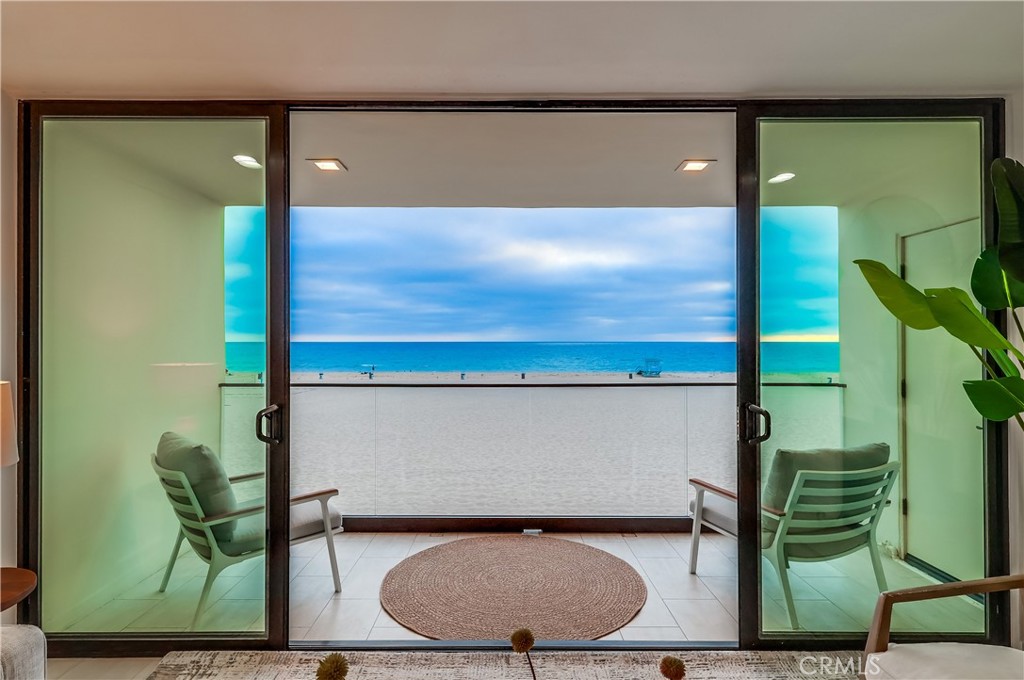 Coastal Luxury on The Strand! Experience beachside living at its finest in this rare, 2-story penthouse on a coveted 90-foot wide lot along The Strand in Hermosa Beach. Enjoy unobstructed panoramic views of the Pacific Ocean and coastline from nearly every room. The spacious primary suite offers a private ocean-facing deck, while the open-concept living, dining, and kitchen areas flow seamlessly to a second private deck—ideal for entertaining. Both bedrooms feature walk-in closets and custom cabinetry, with a private laundry room situated between them. Modern upgrades include central A/C, new finishes, recessed LED lighting, and sleek, contemporary design throughout. Additional highlights include a gated subterranean garage with two side-by-side parking spaces, private storage, and access to a beautifully maintained common patio for entertaining or relaxing outdoors. Just steps from the Hermosa Pier, fine dining, shopping, and Noble Park, this is a once-in-a-lifetime opportunity to own an iconic oceanfront residence—with seller financing available to qualified buyers.