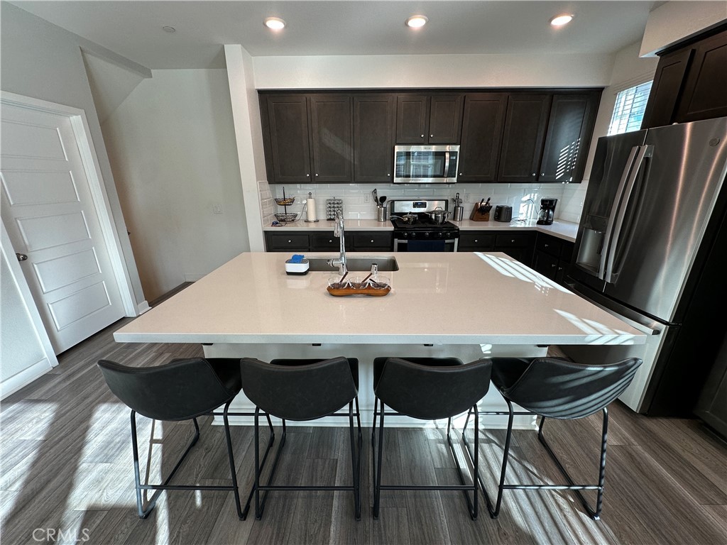 Welcome to 12808 N Watt Lane, and step in to a brand new construction situated in a gated community in the heart of Sylmar! The townhome offers 3 bedrooms and 3 bathrooms, along with a garage equipped with a 40A EV charging outlet. Recently built in 2019, the townhome has only ever been owner-occupied and cared for tremendously. The entry room, connected to the garage, goes upstairs to the open floor plan featuring a beautiful kitchen, tremendous dining area, and extremely comfortable living room. New and clean appliances await you in the kitchen, with a welcome island in the middle to provide even more storage and counter-top space. There is a powder room bathroom for ease of access as well! All bedrooms and the last two bathrooms are located away from the common space upstairs. Each bedroom offers generous closet space and natural light flowing in from the many windows around. This townhome is also conveniently located near major shopping centers, Costco, Lowe's, Best-Buy, and all the freeways you need to get around the Valley!