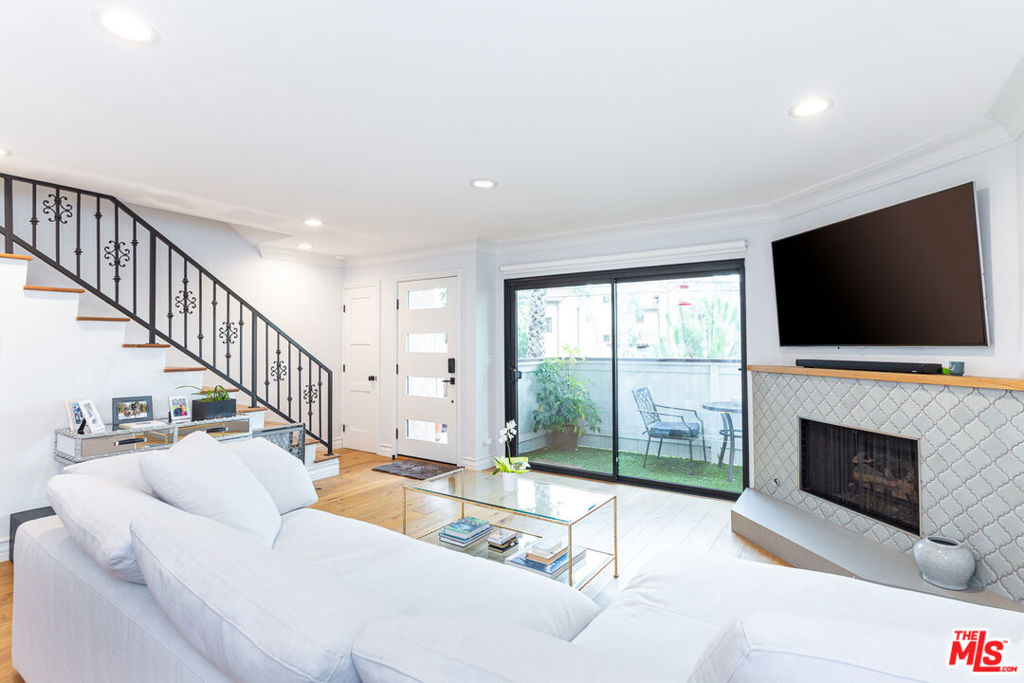 Extensively and stylishly remodeled, this light and bright 2bd/2.5ba + loft townhouse is for lease in a prime Santa Monica location! Just South of Montana Ave, it's just a short stroll to some of the best local coffee shops, restaurants and boutiques that Santa Monica has to offer. Step directly into the open living space featuring a gas fireplace and beautiful hardwood floors. The fully remodeled kitchen is complete with quartz countertops, a custom backsplash, stainless steel appliances and a Bertazzoni Range. Just off of the kitchen is the private back patio, which is 1 of 4 exclusive outdoor spaces, including balconies off the living room and primary bedroom, as well as a roof deck, giving you the true indoor-outdoor living experience. The Primary Bedroom boasts high ceilings, clerestory windows, and a private loft that's perfect for a home office or gym. Gorgeous newly remodeled en-suite primary bath. Blackout shades in both bedrooms. In-unit washer/dryer, 2-car private garage with direct access to the unit. Central Air/Heat. 1-year+ lease, Available September 15. Pets welcome.