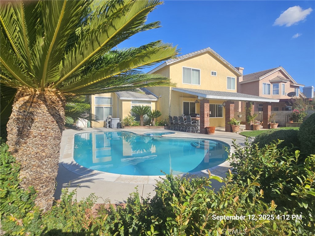 Plenty of time for hot fun in the summertime in this beautiful, well appointed family home that is suitable for ALL KINDS of entertaining! The block wall fenced back yard is completely awesome with beautiful inground pool/spa & concrete decking. The concrete work extends to the back of the lot with a half basketball court ready for you to post up your friends! Don't overlook the outdoor kitchen at the rear covered patio that includes BBQ, sink, refrigerator area & plenty of counter space. The owner has thoughtfully designed the beautifully landscaped yard areas with grass, trees, flowers, block planter boxes & more. The front yard also has established landscaping including the most beautiful large sycamore tree that fully shades the front yard, along with other trees, flowers, shrubs. There is a sheltered porch at the entry with a beautiful security screen door. Inside you will find a floor plan that is perfect for the growing family. Soaring ceilings in the living area (perfect for that Christmas tree placement!). The kitchen has all of the cabinet & counter space you need, including added side cabinets, a pantry, upgraded corian counters & island with seating area. Directly adjacent is the family room with fireplace. One bedroom downstairs had been converted to an office/craft room with LOTS of built in desk/shelf/cabinet areas. Directly adjacent to a full bathroom, this space is ideal for visitors, extended family members, etc. Upstairs you will find the other 3 bedrooms, 2 additional full baths. The primary bedroom has a nicely done walk in closet with built in shelves. The windows all have custom built shutters & the paint color scheme is delightful. There are new baseboards downstairs. Water heater is almost brand new. Newer oven in kitchen. Other features of home have been updated at various times in the past several years. The attached finished 3 car garage completes the picture on this home. All you need to do is move in & start enjoying the rewards that this home has to offer you & your family!