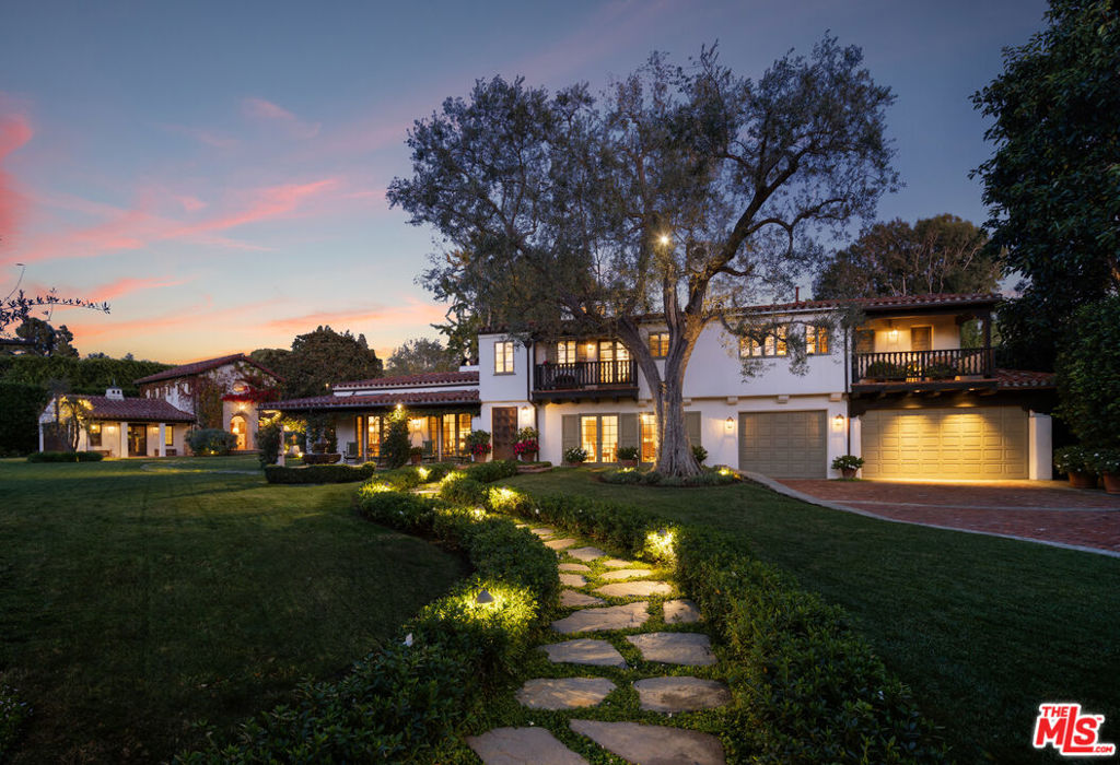 Set behind gates on one of the most sought after streets in Brentwood Park, this exceptionally rare property combines three parcels to form one of the largest properties in the entire park. At nearly 62,000 sf of mostly flat land this property is almost impossible to duplicate. Known as "Camino con Cristo" the main residence is believed to have been designed in 1928 by the famous California architect John Byers. In 2007 renowned architect/designer Thomas Callaway expanded and elevated the main residence which presents dramatic interior spaces adorned with vaulted ceilings, wrought iron details, and double French doors that create an effortless indoor-outdoor flow throughout. It includes formal living, dining, and family room, an eat-in kitchen, a library, an office, and three en-suite bedrooms upstairs - with the primary suite showcasing a fireplace, two bathrooms, a showroom-style closet, and balcony. Later Callaway added a two story two bedroom guest house with a separate stand alone living room / pool house, a Mission Revival chapel, potting shed, additional garage, and stunning timber and masonry loggia. This opulent estate seamlessly blends Spanish Colonial and Mission Revival styles across the sprawling park-like grounds featuring multiple fountains, courtyards, and gardens. Mature trees and tall hedges create a tranquil setting for the manicured grounds. This offering is truly a once-in-a-lifetime opportunity to acquire one of the largest estates in the Park. Located in the highly sought after south of Sunset north of San Vicente location with easy walkability to Brentwood Country Mart, Brentwood Country Club, and easy access to all the world-class amenities the area has to offer.