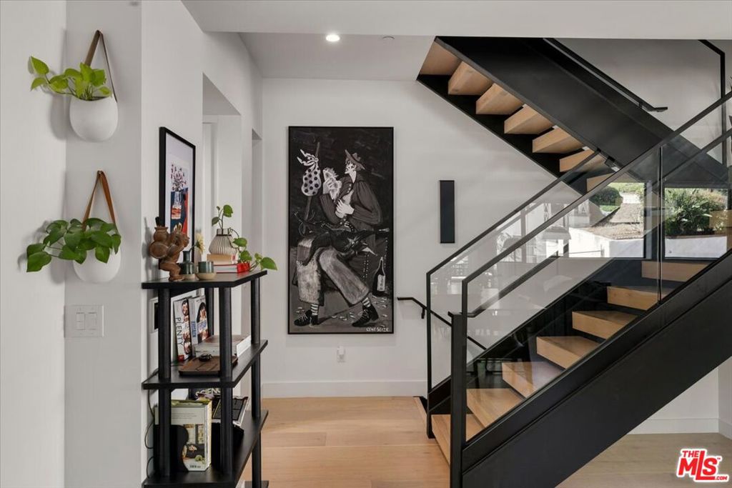 Welcome to 3225 Rowena Avenue, a remarkable residence in the sought-after Los Feliz neighborhood, part of Rowena Walk, a boutique architectural collection of only ten single-family homes that beautifully blend style, light, and function. This stunning home offers 2,218 square feet of thoughtfully designed living space, featuring 4 spacious bedrooms and 3.5 bathrooms. Since purchasing, the owners have made a range of tasteful and practical upgrades, including automatic shades, custom built-ins throughout for extra storage, completely remodeled bathrooms, and a relaxing steam shower in the primary bath. The entry level includes a private bedroom with a thoughtfully integrated bookcase, an ensuite bath, and direct garage access perfect for guests or a home office. The two-car garage is equipped with an EV charger for added convenience. Ascend to the main living level, where oversized windows and high-end finishes flood the space with natural light. High ceilings and a seamless, open floor plan connect the living area complete with a cozy fireplace framed by a reclaimed wood mantle, to an outdoor deck and wraparound private yard. The cook's kitchen features Viking appliances, a built-in reverse osmosis (RO) water system, abundant cabinetry, and a generous center island, ideal for everything from casual meals to gourmet creations. Upstairs, the third level offers three additional bedrooms, including the expansive primary suite with a large custom vanity and walk-in closet, a serene, private retreat. Atop it all, a private rooftop deck provides breathtaking hillside views. Curated with high-end materials throughout, the home also features a tankless water heater, dual-zone AC/heat, and direct-entry garage access. Ideally located in the coveted Ivanhoe school district and just moments from Trader Joe's and beloved eateries like All Time, Blue Bottle Coffee, and Little Dom's. Enjoy close access to the best of Eastside living, with Griffith Park, the Silver Lake Reservoir, the Greek Theatre, and more all within easy reach.