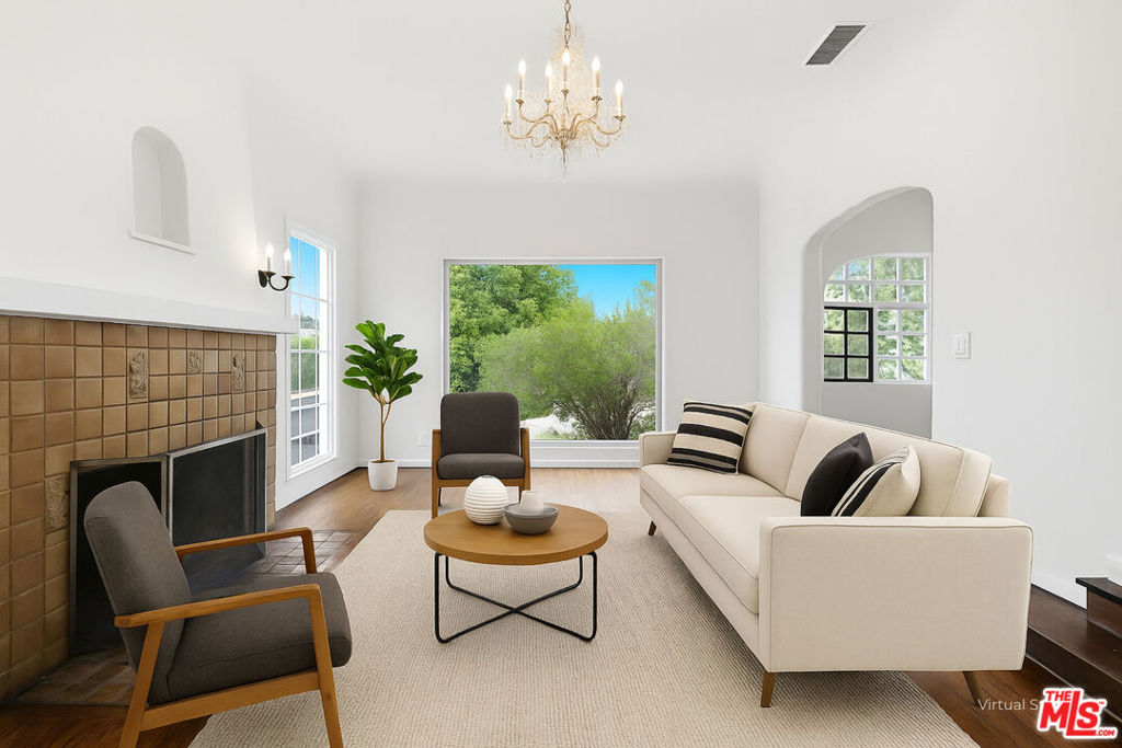 Welcome to 2132 Cove Ave, a bright and inviting 4-bedroom, 3-bath home with a den, tucked away on a peaceful street in the heart of Silver Lake. This storybook-style cottage blends timeless architectural character with the space and amenities you need for modern living. Inside, you'll find sunlit rooms with large windows, a generous living area, and a flexible floor plan ideal for families, creatives, or anyone needing extra room for a home office or studio. The updated kitchen and dining spaces flow seamlessly, perfect for both daily life and entertaining. With four spacious bedrooms, three full bathrooms, plus a den, there's plenty of room to spread out. Step outside and enjoy a pool plus a tranquil setting surrounded by greenery offering both privacy and convenience. The Mattachine Stairs are right outside your door front. Perfect for a workout. Just minutes from Silver Lake Reservoir, Sunset Junction, and the area's best coffee shops, boutiques, and restaurants, you'll be at the center of one of LA's most vibrant communities.