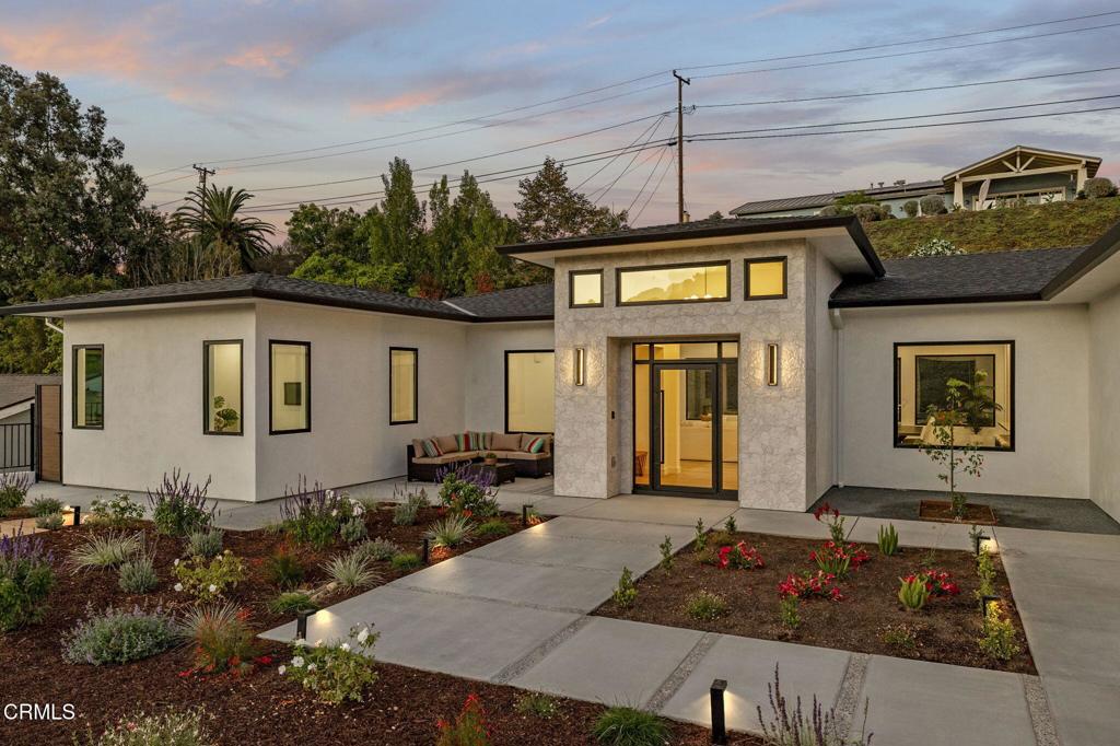 Welcome to Ondulando! A rare opportunity to own a brand-new construction home in one of Ventura's most sought-after neighborhoods. This modern single story residence is crafted with unparalleled attention to detail, thoughtful design, and high-end finishes. Inside you are greeted with an open concept floor plan perfect for entertaining and featuring elegant white oak engineered hardwood floors throughout. The chef's kitchen showcases top of the line appliances, a striking 9-foot center island, and a seamless flow into the spacious living room with 74' WiFi-enabled color changing LED fireplace adding to the inviting ambience of the home. This 4-bedroom, 4-bathroom masterpiece redefines luxury living with its split wing layout featuring two primary suites with incredible bathrooms with modern finishes, and each with private access to the covered patio. The extra spacious laundry room with ample cabinet space provides additional storage along with the two entry closets and hallway linen closet. Every detail was designed with efficiency and comfort in mind: individually zoned mini-split heating and cooling, a fully integrated solar system pre-wired for backup battery and EV charging readiness. Smart home upgrades include Ring doorbell, Sonos sound system with iPad control, and more! Spacious two car garage complete with epoxy finish. Step outside to your own private outdoor retreat featuring multiple sitting and dining areas, a fully equipped outdoor kitchen, fire pit, and tranquil fountain--the perfect setting for gathering year-round. From smart design to outdoor entertaining, this home delivers everything you've been waiting for! Come experience the perfect blend of luxury, innovation, and California living in this one-of-a-kind Ventura home.