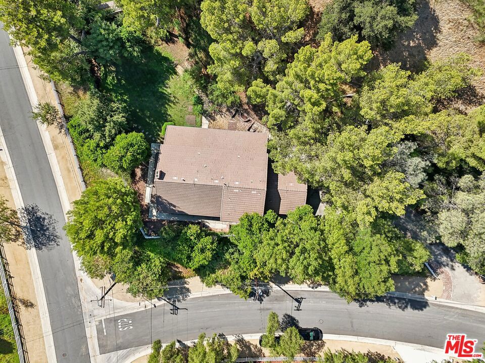 Nestled within the much sought after gated community of Hidden Hills. This 5 bedroom, 3 bath original ranch-style residence and adjacent lot are situated on a quiet cul-de-sac street offering a rare opportunity for those with a vision to create their dream home. Whether you're a developer looking to craft a luxurious masterpiece or an end-user with an eye for potential, this property offers a blank canvas for transformation. Hidden Hills is celebrated for its suburban tranquility and California charm, making it one of Southern California's most coveted gated communities. Whether you choose to embrace it's original charm or reimagine it entirely, this property is a true hidden gem with endless potential. Embrace the chance to bring new life to a property in one of Southern California's most desirable communities. Hidden Hills offers 35 miles of winding horse trails, riding arenas, tennis courts and a community theater; the possibilities for recreation and enjoyment are endless. Beyond the gates, further outdoor adventure awaits on the trails of Ahmanson Ranch, perfect for hiking and exploring the natural beauty of the region. In addition to its peaceful setting, Hidden Hills is located in close proximity to upscale boutique shopping, five-star eateries, and provides an easy commute to the beautiful beaches of Malibu. Included in the sale is an adjacent vacant lot. The primary lot (APN 2049-026-035) measures 57,673 Sq. Ft . Adjacent vacant lot (APN 2049-026-05) measures 49,471 Sq. Ft. Total for both APN's is 107,244 Sq. Ft. per tax assessor.