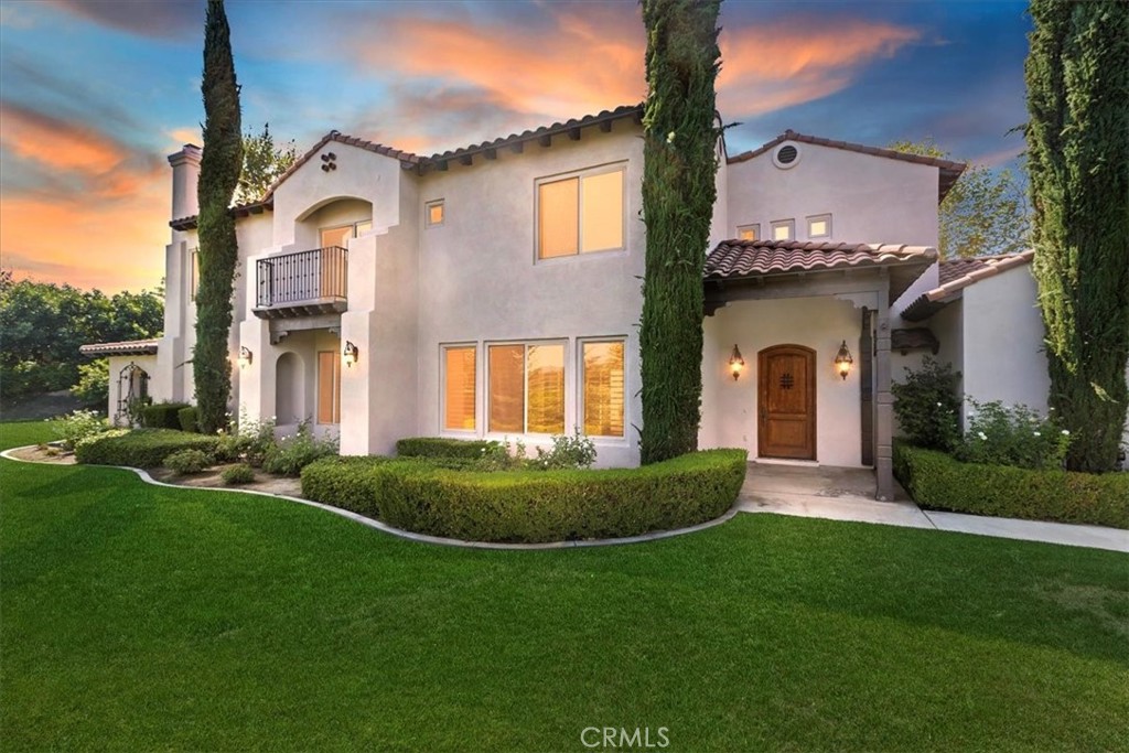 Nestled within the exclusive gated community of Hidden Canyon, this Mediterranean estate offers a perfect blend of luxury, comfort, and timeless design. Boasting 4,301 square feet of living space, this stunning residence features 5 bedrooms and 4 full bathrooms, with soaring ceilings and 8-foot tall Pecky alder doors enhancing its elegant appeal. A thoughtfully designed floor plan includes a private downstairs bedroom with a full bath and direct access to a serene courtyard, ideal for guests or multi-generational living. The chef’s kitchen is a true showpiece, equipped with high-end appliances
including a 48” range with dual ovens and griddle, separate built-in convection oven, warming drawer, and a KitchenAid refrigerator. Granite counters, travertine floors, and a spacious walk-in pantry conveniently located in the laundry room complete this impressive space. The expansive primary suite is a private retreat, offering a large walk-in closet, dual vanities, walk-in shower, and a relaxing soaking tub. Outdoors, enjoy an acre of beautifully landscaped grounds designed for entertaining and relaxation. A covered patio with TV, a generous fire pit, and breathtaking views of city lights
and mountain vistas create the perfect setting for gatherings. Additional highlights include two cozy functional work spaces, 4-car garage with epoxy floors and abundant storage, wood shutters, central vacuum system, as well as dual AC units for year-round comfort. Every detail has been carefully curated to offer both luxury and functionality in one of the most desirable communities.