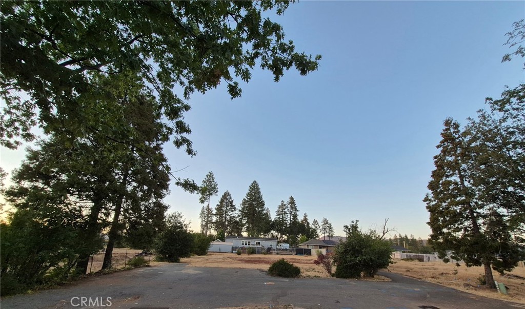 Located in a desirable area, this beautiful and well-maintained lot offers an excellent opportunity for rebuilding in a peaceful residential setting. The flat 1/3 acre parcel provides ample space for future development, outdoor activities, or customized landscaping. An existing asphalt driveway and designated RV parking enhance convenience, while nearby utility connections simplify the construction process. Residents will enjoy easy access to essential amenities, including grocery stores, shops, restaurants, a post office, and banking services - all just minutes away. It is also just walking distance to Paradise Ridge Elementary School.This property. combines practicality with potential, making it an ideal choice for those looking to create their dream home in a well-connected neighborhood. Previous home was 1800 plus square feet, 3 bdrm and 3 car garage