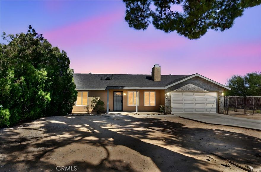 MOVE IN READY! Welcome to this inviting single-story residence, ideally situated on a generous 0.66-acre lot in Hesperia’s established family area. Boasting 3 bedrooms, 2 full bathrooms, and approximately 1,348 square feet of living space, this home offers both comfort and convenience to everything to make this house a home. Step inside to a warm and open floor plan anchored by a stone fireplace in the living room, accented with ceiling fans and fresh finishes. The adjacent kitchen features a walk-in pantry, built-in stove, dishwasher, and convenient layout to serve family and guests.  The home includes a two-car attached garage, a fully fenced yard, and a storage shed — ideal for outdoor projects or hobbies. Built in 1982, this home enjoys a solid foundation with upgrades including newer windows, lighting, paint and flooring. Nestled within the Hesperia community, residents enjoy a desert setting with easy access to major thoroughfares, local schools, shopping, medical, and daily conveniences. Nearby schools include Carmel Elementary, Ranchero Middle, and Sultana High School — each within a few miles of the property.