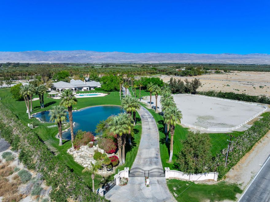 Beautiful equestrian compound!  Great for horses, grand event or even your own personal estate.  This approx. 9,131 SF home is located on 9.29 Acres.  Enter through private electric gates and proceed up a meandering driveway past a large man-made lake with a beautiful waterfall to the main house.  Step into the large foyer into an impressive living room with an oversized fireplace.  The family room has a large bar and custom built-ins.  Spacious kitchen with a large center island.  The primary suite has dual walk-in closets (one with a large storage room attached), a powder/sitting room and an extra dressing room.  The second primary suite has a living room, large walk-in closet and a full private bathroom.  Each of the three guest suites have private full bathrooms.  The main house has a large laundry room, wine cellar, cedar lined storage closet and a full dog kennel with a large built-in dog bath and fenced dog yard.  There are four large garages with three very large storage rooms and a 5 gallon bottled water storage room.  The guest house has three separate living quarters (studio and two 2 bedroom apartments) and two additional garages, one being a large RV garage.  Additional property features include a huge covered patio, pool & spa, gazebo, two barns (one with caretakers quarters) with approx. 14 stalls, tack room with private full bathroom and a kitchen, multiple riding arenas, a large horse arena, pastures, an orchard and over 6 acres of turf.  Many sitting areas with built-in benches throughout the property.  There is a gym is with a full size multifunctional gym system, multiple closets and a large storage room attached.  The orchard has its own well and is connected to the city as well.  The possibilities are endless with this exceptional property.  Total privacy abounds, yet you are only 2-4 miles from dining, shopping and schools.