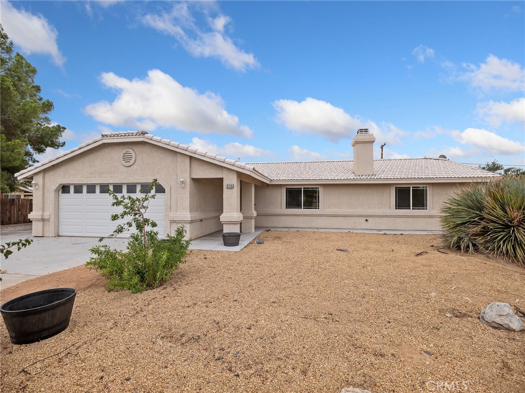 Fabulous & Freshly updated and move-in ready! This Apple Valley home features brand new carpet and paint throughout, creating a bright and inviting interior. Enjoy the fully enclosed patio for extra living space and year-round use. The property is completely fenced and landscaped with low-maintenance rock scape plus mature fruit trees. A large 4-car detached garage in the rear yard offers plenty of parking, storage, or workshop potential. Conveniently located near schools, shopping, and services, this home is ready for its new owner.