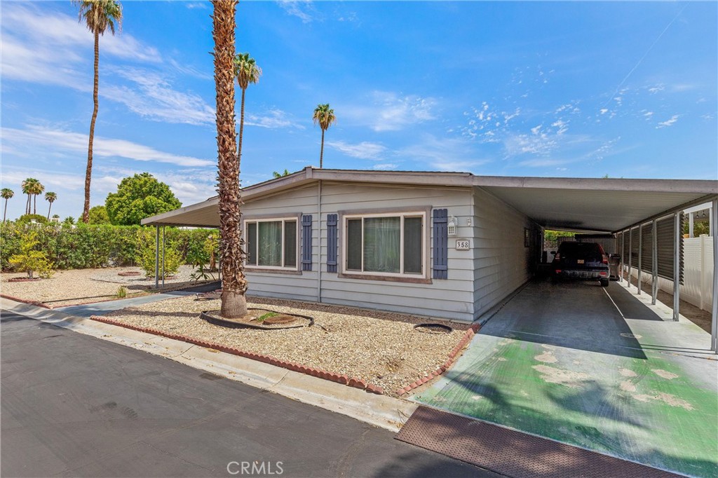 One of The largest lots in El Dorado Palms, at 5,266 Sq Ft, allows you to either add on to the existing house, or put a brand new house on the lot. The house has two bedrooms, two baths, Family room, formal living and dining rooms, large covered patio and covered carport. All this in a gated premier 55+ complex on fee land, you own the land, with pools, spas, tennis courts, club house with gym, and RV parking for residents. The 1440 Sq Ft home also has a separate laundry room, fully equipped kitchen with double wall ovens, gas cooktop, and refrigerator. For Just $249,000, you won't find a better bargain in South Palm Springs. Enjoy the mountain views from the Living Room also.