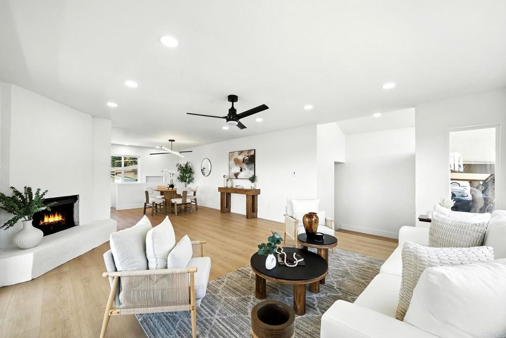 Welcome to this beautifully upgraded tri-level residence nestled on a spacious corner lot in highly desirable Bay Park! Featuring 4 bedrooms, 3 bathrooms, and a 2-car garage, this light-filled home offers comfort, style, and flexibility for modern living. With two primary suites each with a private bathroom and one boasting a walk-in closet this layout is ideal for multi-generational families or guests. Enjoy the elevated living room with a cozy fireplace and a balcony that offers peek-a-boo views of Mission Bay, perfect for sunsets and entertaining. The remodeled kitchen showcases sleek quartz countertops and opens seamlessly to the dining area. All bathrooms have been tastefully remodeled with high-end finishes, and new luxury vinyl plank flooring runs throughout the home. Additional highlights include upgraded plumbing, exterior access, and two fireplaces for added warmth and charm. The large backyard provides ample space for outdoor living or future expansion, including ADU potential for added income or extended family. This is a rare opportunity to own a versatile and beautifully updated home in one of San Diego’s most sought-after neighborhoods just minutes from beaches, parks, shopping, and top-rated schools!