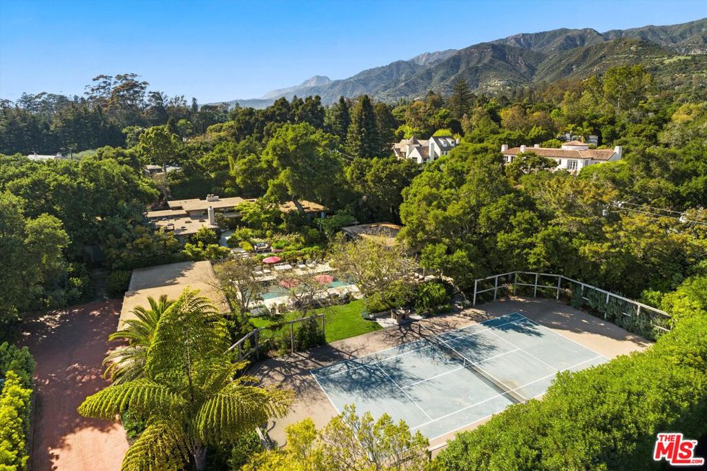 A Private Zen Retreat in the Heart of Montecito Tucked behind gates on a peaceful lane, this single-level Mid-Century estate is a tranquil sanctuary where nature and luxury converge. Lush tropical landscaping, curated pathways, and serene outdoor moments create a resort-like atmosphere. Inside, soaring ceilings and walls of glass frame garden views, while a chef's kitchen, dramatic agate fireplace, and seamless indoor-outdoor flow elevate everyday living. The spa-inspired primary suite features radiant heated floors, steam shower, ceiling-fill soaking tub, and private garden with hot tub and outdoor shower. Two additional en-suite bedrooms and two offices offer flexibility and comfort. A sparkling pool, modern cabana with bar and home theatre, outdoor kitchen, tennis court, and smart home systems complete this exceptional retreat. Experience the ultimate Montecito lifestyle private, peaceful, and unforgettable. This Shangri-La is waiting for you!
