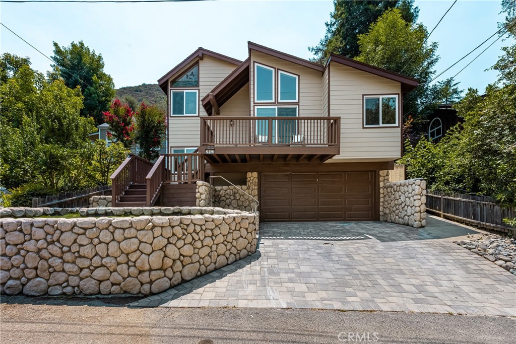 Welcome to your dream retreat—where modern comfort meets the serene beauty of nature. This stunning 3-bedroom, 2-bathroom canyon home offers the perfect blend of style, sustainability, and tranquility. Nestled in a picturesque setting with panoramic canyon views, this property is a true sanctuary for nature lovers and outdoor enthusiasts alike. Inside, the thoughtfully designed floor plan features two spacious bedrooms and a full bathroom on the lower level—perfect for guests, family, or a home office setup. Upstairs, you'll find a private and expansive primary suite that serves as a luxurious escape. The suite includes a separate room with a walk-in closet, laundry room and wash tub for added convenience, and an upgraded spa-inspired bathroom with a large upgraded shower and dual ‘his-and-her’ vanities. The inviting living room boasts a cozy wood-burning fireplace, while the upgraded kitchen is equipped with sleek countertops, premium appliances, designer cabinets, a wine refrigerator, and opens to a stylish wet bar—ideal for entertaining. Wrapped in durable, upgraded Hardie board siding and finished with fresh exterior paint, the home radiates curb appeal. Energy-efficient solar panels and a state-of-the-art home battery backup system provide self-sufficiency and year-round peace of mind. An attached 2-car garage offers ample storage, and the surrounding natural landscape completes this peaceful setting. This is more than just a home—it’s a self-sustaining canyon oasis designed for comfort, style, and everyday adventure. Located on the prestigious Olive Hill, this home is adjacent to both Tucker Wildlife Sanctuary and the popular Harding Truck Trail for both hiking and mountain biking. The tightly knit community of Modjeska Canyon offers lots of events throughout the year to bring the community together making it a unique and special place to call home. Don’t miss the opportunity to own this exceptional canyon retreat.