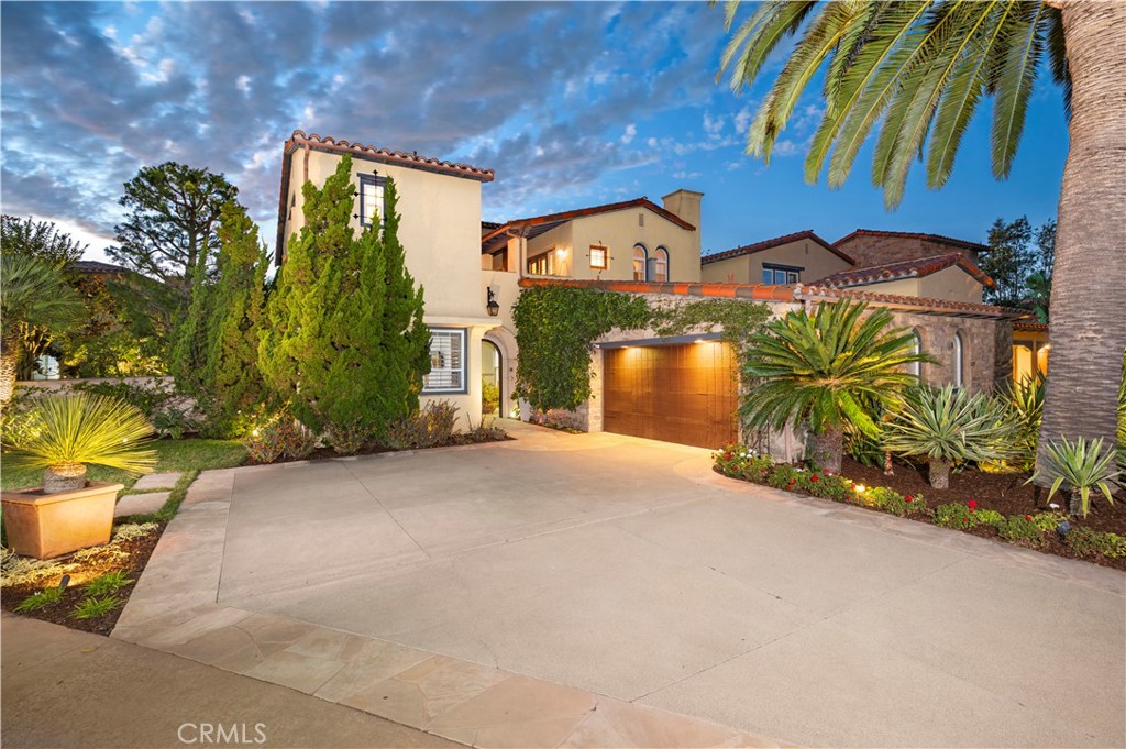 Perched within the prestigious guard-gated community of Ocean Heights, this exquisite estate offers sweeping vistas of the Pacific Ocean, Catalina Island, glittering city lights and mountain views. Thoughtfully designed for privacy and flexibility, the residence features separate entrances to a casita and a guest quarters—perfect for visiting family, extended stays, or a private home office. The upper level of the main house is devoted to a grand primary suite, complete with a cozy fireplace, spacious walk-in closet, and a luxurious bath retreat—all framed by the property’s breathtaking views. A third-floor flex space off the primary suite provides an ideal area for a gym, art studio, or private office.
Inside, timeless architectural details—such as exposed wood beams, French doors, and rich hardwood flooring—create a warm, elegant ambiance. A gourmet kitchen with high-end appliances opens to a private inner courtyard with fireplace and a charming fountain, ideal for morning coffee, casual meals, or intimate gatherings.
Designed for seamless indoor-outdoor living, the backyard retreat features private terraces, BBQ, a fireplace, a fountain, a fire pit, lush landscaping, and a spa, all overlooking some of the most commanding views in Newport Coast. From sunrise to sunset, every moment is elevated by the dramatic scenery.
Living in Ocean Heights offers more than a home—it provides a coveted lifestyle. Residents enjoy 24-hour guard-gated security, meticulously maintained grounds, and proximity to award-winning schools, Crystal Cove State Beach, Pelican Hill Resort, and premier dining and shopping at Fashion Island and South Coast Plaza. This property exemplifies luxury, privacy, and the quintessential coastal California experience.