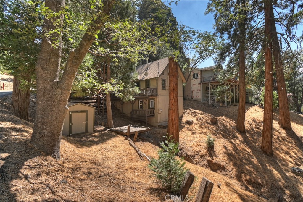 Charming Mountain Retreat on a Corner Lot
This inviting mountain home offers the perfect blend of vintage character and thoughtful updates. Step inside and you’ll be welcomed by warm wood accents, a striking rock fireplace, and a cozy layout that instantly feels like home. The kitchen has been refreshed with updated countertops and is ready for your next gathering. The main-level bedroom features a generous closet, while upstairs you’ll find two additional sleeping areas and a convenient half bath—accessible by a private exterior staircase, making it a unique space for guests or family.
Outside, the deck area is waiting for your personal touch—bring your toolbelt and creativity to unlock its full potential. Below the main living space, the buildup includes the laundry area and plenty of storage. With the floor furnace replaced in 2013 and some TLC, this home is ready to shine once again. Priced right, it’s an opportunity for its next owners to enjoy mountain living at its best.