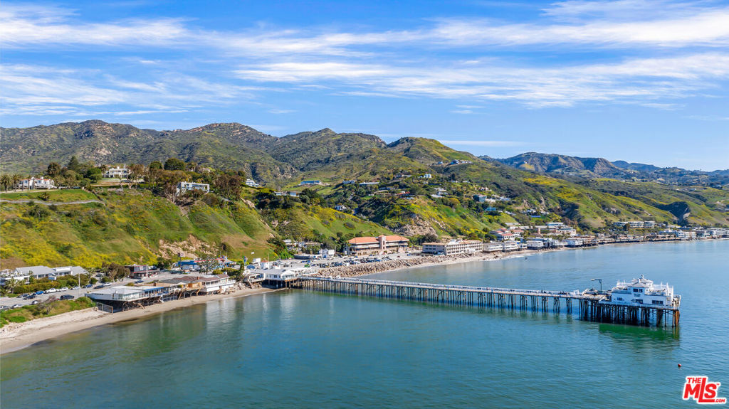 Welcome to your dream beach house in the heart of Malibu! This beautiful home has been cared for and loved by one family for the last 50 years and is now ready for its next lucky owner. The house is a two-bedroom, two-bathroom gem, one of only 6 homes that sits adjacent to the iconic Malibu pier and overlooks Surfrider beach, offering breathtaking views of the Pacific Ocean. As you step inside, you'll be transported to a bygone era with the beautiful 1950s architecture and detail. The house is designed for comfort and relaxation, with a galley style kitchen and dining area that overlooks the ocean. The spacious living room features large windows that let in plenty of natural light and offer panoramic views of the beach. The house also has a beautiful deck that is the perfect spot to savor a cup of coffee in the morning, enjoying the sunrise or barbecuing in the evening, while taking in the expansive ocean views, sunsets, surfers, dolphins and seabirds. From here, you'll have direct access to the most famous beach in Malibu where you can enjoy activities or simply soak up the sun. You'll also be just a short distance from Cross Creek, which boasts some of the best restaurants and shops that Malibu has to offer. The location and beauty of this house is truly unbeatable.