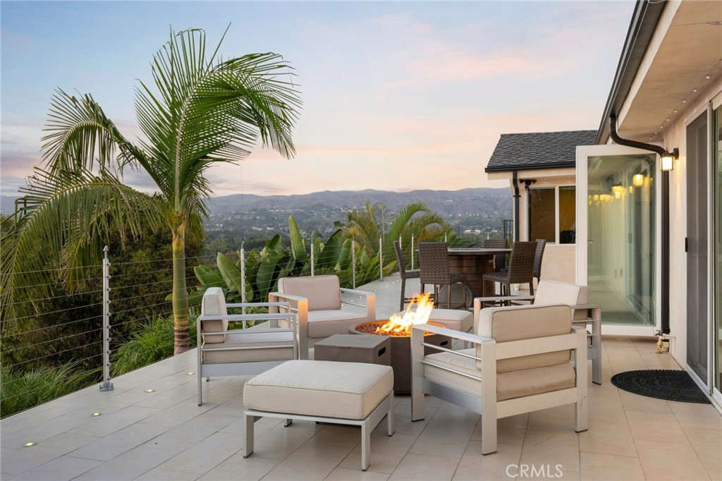 Exceptional Luxury Custom Estate with Panoramic Views, Total Privacy & World-Class Amenities. Welcome to this one-of-a-kind custom estate, a private sanctuary nestled on over 1 acre of professionally landscaped grounds. Perfectly positioned to capture breathtaking views of the surrounding cityscape and majestic mountains, this newly remodeled masterpiece seamlessly blends modern luxury, timeless design, and resort-style living. From the moment you arrive through the private gated entrance, you’re greeted by a sense of exclusivity and sophistication. A long driveway leads you into the heart of the estate, where lush landscaping, Adobe accent lighting, and custom water features create an ambiance of serene luxury. The property features multiple outdoor entertainment areas, each thoughtfully designed for gatherings, celebrations, or simply relaxing under the stars. With two full outdoor kitchens, custom patio up lighting, and exterior landscape lighting, the outdoor experience is both inviting and unforgettable. The centerpiece of the backyard is a newly built infinity-edge pool with a soothing 8-person Jacuzzi, surrounded by beautifully designed hardscapes and greenery. The private courtyard offers an additional outdoor escape, perfect for morning coffee or evening wine. Step inside to a home that has been thoughtfully remodeled inside and out, with professionally designed flooring throughout, custom folding doors that open to a sprawling oversized deck, and recessed lighting that brings warmth and style to every room. The interiors are filled with natural light, thanks to newer energy-efficient windows, and offer the perfect balance of open space and cozy living. At the heart of the home is a true chef’s kitchen, designed with culinary excellence in mind. Featuring Cesarstone countertops, custom cabinetry, a walk-in pantry, and stainless steel appliances, this kitchen is both a showpiece and a functional space for everyday use or entertaining on a grand scale. A wet bar adds a touch of sophistication, making this home perfect for hosting and entertaining. This property isn’t just a home—it’s a lifestyle. Whether you’re entertaining large groups, enjoying a quiet evening by the pool, or taking in the sunset from your private deck, this estate offers the ultimate in luxury, privacy, and comfort. A rare opportunity to own an extraordinary custom home where every detail has been perfected.