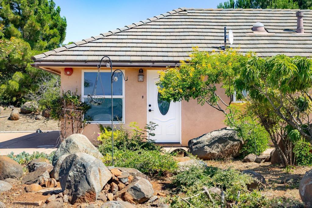 From the very beginning, this property was designed for expansion. When the guest house was built, plans were approved (likely would need to be updated) around 2005 for a custom 2,900 sqft, 4-bedroom, 3-bath primary home. Today, a completed building pad stands ready, awaiting your vision. All essential utilities are installed and ready to go, including two separate 1500-gallon septic tanks – one dedicated to the guest house and another specifically for your future primary residence. Two separate addresses, 38960 and 38962 allocated to this property, along with an RV pad with hook-ups for all your recreational needs. Nestled within the prestigious, gated Rancho Heights community in Pala, this exceptional property offers a rare blend of comfortable living and limitless potential. The guest house, built in 2005, provides a sophisticated retreat spanning 603 sqft. It features a beautifully appointed kitchen with granite countertops and extensive use of travertine flooring throughout. The bedroom boasts a walk-in closet, and the bathroom is equally luxurious.
