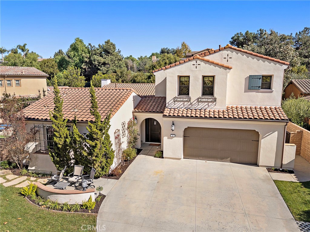 Representing the pinnacle of hard-earned success and reflecting your exquisite sense of style, this newer custom-caliber home is move-in-ready at guard-gated Covenant Hills in Ladera Ranch. Located on a generous homesite near the end of a quiet cul-de-sac in the exclusive Warmington Legacy collection, the residence is extensively upgraded. Slide-away and Multiple sets French doors create a desired indoor/outdoor ambiance throughout approximately 4,225 square feet of refined living space, which reveals five ensuite bedrooms and five- and one-half baths. A formal entry with tongue-and-groove ceiling leads to a double-height foyer with a grand staircase and access to a private courtyard. Beyond the foyer, expansive living areas flow easily from one to the next, including a dining room, and a fireplace-warmed family room with open-beam vaulted ceiling, built-in bar with under-cabinet beverage refrigerators, surround sound, and slide-away glass door. One opens to a side yard with built-in BBQ and separate built-in Big Green Egg for grilling, smoking, roasting and baking. Explore additional culinary adventures in a fully appointed chef-style kitchen with handsome stained-wood cabinetry, dark quartz countertops, an oversized island with butcher-block and lite quartz top, separate desk niche, walk-in pantry, a six-burner range with griddle and two ovens, and 5 feet of built in refrigerator/freezer. Three bedrooms are located on this level, including two secondary suites, and a private primary suite with direct access to the courtyard. Enjoy a vaulted ceiling, walk-in closet with custom furniture-quality built-ins, a soaking tub, separate shower and individual vanities. An enormous loft with surround sound is showcased upstairs, providing an ideal setting for a home theater, game room and more, while two secondary bedroom suites are impressively sized. Owned solar, security system, surround sound speakers an ample laundry room with cabinetry, arched passageways, designer paint and wall treatments, high-end carpet upstairs, & new wide-plank French oak flooring downstairs are proudly displayed. Sprawling grounds wrap around the home & boast a pool w/ rain fountain, separate spa, front lawn & back/side turf, separate dog run & spacious paver-finished patios. An oversized driveway welcomes guest parking, & the home backs to a hill for extra privacy. Covenant Hills’ clubhouse is moments way, & trails, parks, shopping, restaurants, top schools & local beaches are nearby.
