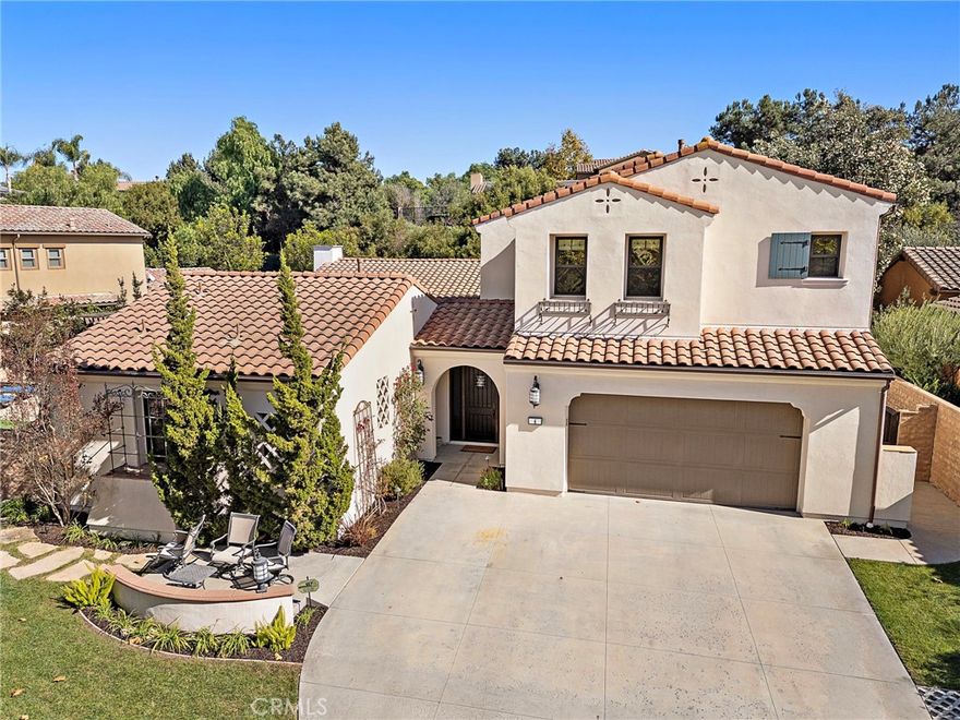 Representing the pinnacle of hard-earned success and reflecting your exquisite sense of style, this newer custom-caliber home is move-in-ready at guard-gated Covenant Hills in Ladera Ranch. Located on a generous homesite near the end of a quiet cul-de-sac in the exclusive Warmington Legacy collection, the residence is extensively upgraded. Slide-away and Multiple sets French doors create a desired indoor/outdoor ambiance throughout approximately 4,225 square feet of refined living space, which reveals five ensuite bedrooms and five- and one-half baths. A formal entry with tongue-and-groove ceiling leads to a double-height foyer with a grand staircase and access to a private courtyard. Beyond the foyer, expansive living areas flow easily from one to the next, including a dining room, and a fireplace-warmed family room with open-beam vaulted ceiling, built-in bar with under-cabinet beverage refrigerators, surround sound, and slide-away glass door. One opens to a side yard with built-in BBQ and separate built-in Big Green Egg for grilling, smoking, roasting and baking. Explore additional culinary adventures in a fully appointed chef-style kitchen with handsome stained-wood cabinetry, dark quartz countertops, an oversized island with butcher-block and lite quartz top, separate desk niche, walk-in pantry, a six-burner range with griddle and two ovens, and 5 feet of built in refrigerator/freezer. Three bedrooms are located on this level, including two secondary suites, and a private primary suite with direct access to the courtyard. Enjoy a vaulted ceiling, walk-in closet with custom furniture-quality built-ins, a soaking tub, separate shower and individual vanities. An enormous loft with surround sound is showcased upstairs, providing an ideal setting for a home theater, game room and more, while two secondary bedroom suites are impressively sized. Owned solar, security system, surround sound speakers an ample laundry room with cabinetry, arched passageways, designer paint and wall treatments, high-end carpet upstairs, & new wide-plank French oak flooring downstairs are proudly displayed. Sprawling grounds wrap around the home & boast a pool w/ rain fountain, separate spa, front lawn & back/side turf, separate dog run & spacious paver-finished patios. An oversized driveway welcomes guest parking, & the home backs to a hill for extra privacy. Covenant Hills’ clubhouse is moments way, & trails, parks, shopping, restaurants, top schools & local beaches are nearby.
