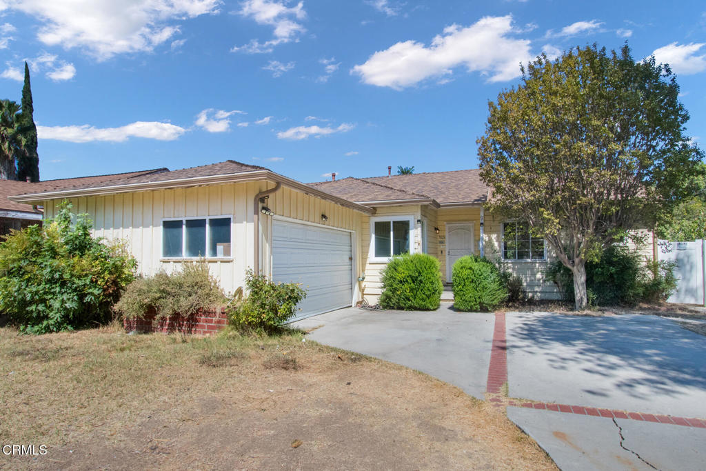 This fixer-upper property offers significant potential and upside opportunities. It features a ranch-style home with three bedrooms, including a primary bedroom, and two updated bathrooms. The living room features a fireplace, and the space also includes a dining area and a kitchen that opens to a separate laundry room. Additionally, the home features an attached game room, complete with a pool table, a seating area, and a wet bar. The property features a large rear yard with an additional storage shed.