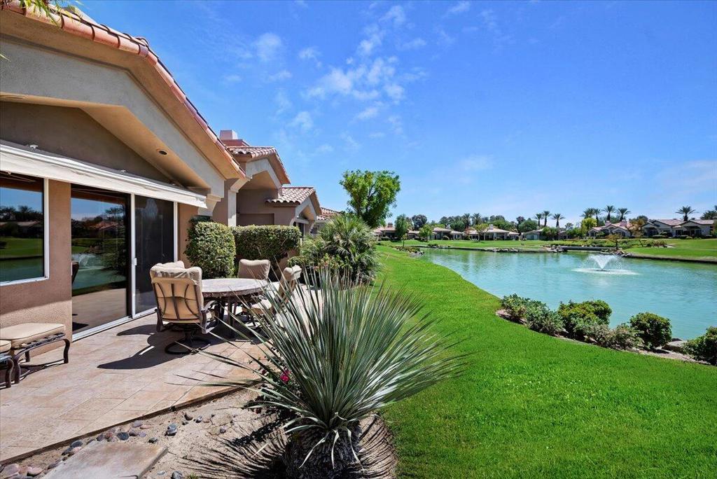 Great value for a south facing water view condo in the highly sought-after Indian Ridge County Club community. This beautiful location offers breathtaking views over the 7th hole of the Grove Golf Course, providing a serene backdrop to your daily life. With 3 spacious bedrooms and 3.5 luxurious baths, this home is designed for comfort and style.The condo features a private entrance, ensuring both security and exclusivity. The living and dining rooms are perfect for entertaining, while the golf course patio with a lake view offers a tranquil space for relaxation. This home is offered fully furnished, as per the inventory list, allowing for a seamless move-in experience.Situated within a well-maintained HOA, residents enjoy hassle-free living with all gardening, exterior maintenance, cable TV, internet, pest control, and roof upkeep included. The location is unbeatable, just moments away from the premier shopping and dining options of El Paseo. This is a rare opportunity to own a piece of paradise in one of the desert's most desirable communities. Property does not have a registered membership.