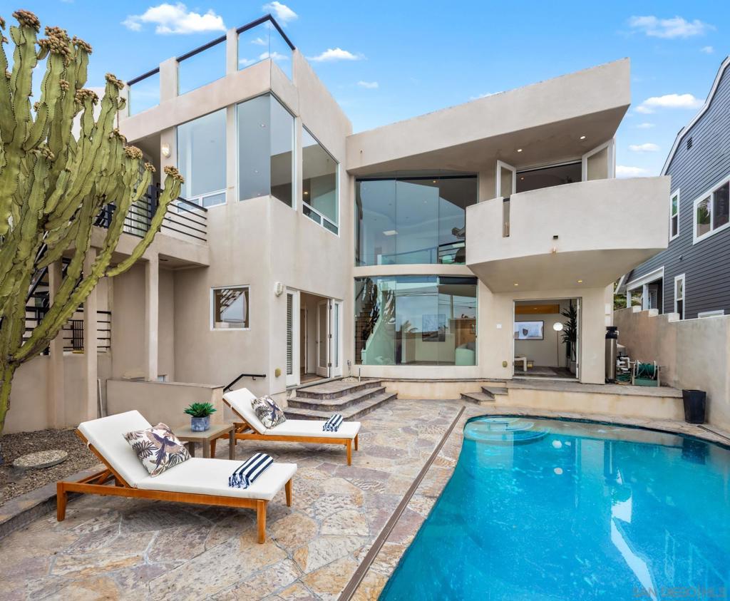 Nestled in Cardiff-by-the-Sea’s prized Walking District, this coastal contemporary masterpiece—crafted by renowned architect Kevin Farrell—offers an inspired blend of architectural elegance and awe-inspiring ocean views. Spanning 3,265 square feet, this custom 5-bed, 3.5-bath residence is designed to capture the essence of seaside living. From the moment you step inside, floor-to-ceiling windows in the living and family rooms frame sweeping, unobstructed views of the Pacific, flooding the home with natural light. An open-concept layout flows effortlessly to the outdoors, where a rooftop deck invites sunset soirees and a sparkling pool promises year-round enjoyment. Warm hardwood floors, two inviting fireplaces, and a flexible bonus room—perfect for a nursery, yoga studio or home office—add comfort and versatility. A detached garage with alley access provides ease and privacy, while central heating and AC ensure effortless living in every season. Behind these walls lies a world of re-imagining and potential—just waiting for your creative touch to transform it into the home of your dreams. Craft your personal seaside sanctuary—add a fence and gate to transform the generous front yard space into a private, breezy coastal hideaway while entertaining guests on the ocean view outdoor space. This home offers an opportunity to remodel and personalize a coastal gem with significant architecture! All this, just steps from Cardiff’s iconic beaches, Seaside Market, and beloved local cafés and eateries. This is more than a home—it’s a front-row seat to the best of SoCal coastal living.