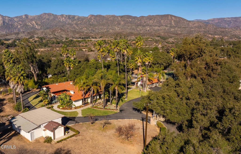 This beautiful private oasis spanning over two acres features a spacious guest house, a pool, a large covered outdoor entertainment area with kitchen, a tennis court, and a horse pasture. The charming 3br/2.5ba hacienda-style main home has stunning natural light throughout, vaulted ceilings, saltillo tiles, 2 stone fireplaces and serene views of the private park-like grounds with mature trees and a lush courtyard patio with a fountain. The kitchen and bathrooms have been renovated with high end appliances and fixtures. The sprawling one-bedroom guest house features soaring ceilings and a large living room, offering ample space and privacy for guests. There is also a separate, oversized garage/studio with access to a full bathroom which is perfectly suited for a future ADU. The beautifully remodeled pool and spa gives the property the feel of a private resort, perfect for relaxation or entertaining. The large covered outdoor kitchen and entertainment area make hosting effortless, while the tennis court and horse area add to the property's unique versatility. Whether you're seeking a serene retreat or a vibrant space for gathering, this exceptional property delivers it all.