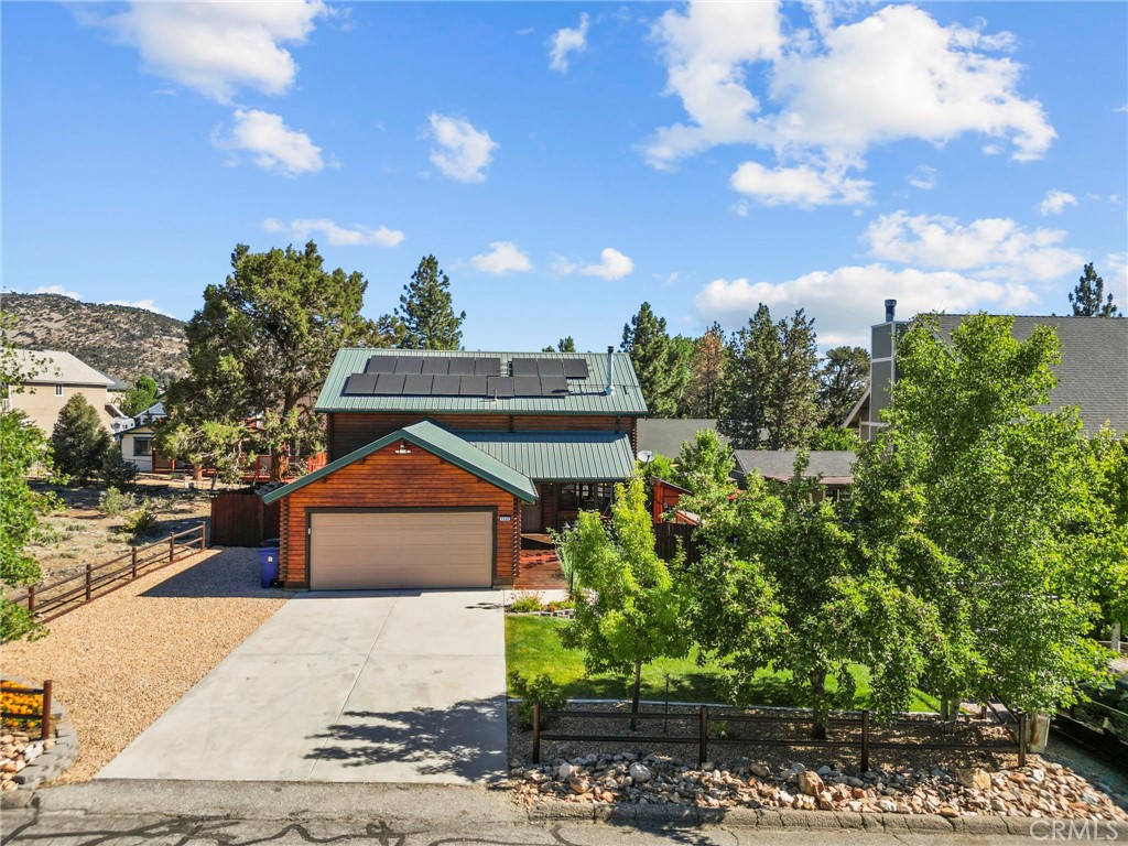 Escape the city bustle to your Big Bear sanctuary! This thoughtfully updated 3-bed, 2-bath mountain home is ideal for remote work, offering a seamless blend of modern comfort & natural beauty. Inside, discover refinished floors, custom cabinetry, granite countertops, and a spacious living area with a cozy wood-burning stove. An open loft provides flexible space for an office or relaxation. Experience true peace of mind with modern upgrades throughout: owned solar panels for low energy costs, an EV charging station, a robust security alarm system with cameras, and a durable metal roof.
The fully fenced, meticulously landscaped backyard is your private oasis. Enjoy enchanting up tree lighting, abundant fruit trees (apple, cherry, peach, pear), a gas firepit, and a private hot tub for ultimate relaxation. A chicken coop or extra storage under deck adds versatility. Located in a sought-after Big Bear neighborhood, near schools, and known for its welcoming community, this home combines smart features and beautiful outdoor spaces—ready for mountain living in every season.