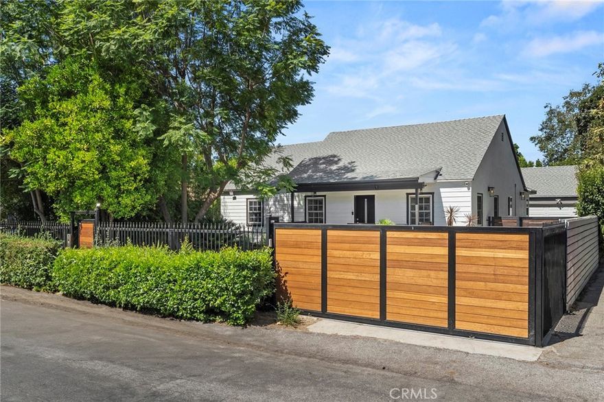 Come see this beautiful remodeled, gated sanctuary in Prime Valley Village! Offering nearly 2,000 sqft. of luxurious living space, plus a private bachelor suite with its own bathroom. Step inside to a seamless open floor plan where the living room, dining area, den, and chef’s kitchen blend effortlessly. The gourmet kitchen boasts stainless steel appliances, a spacious center island, and designer finishes perfect for both cooking and entertaining. Your primary retreat features direct backyard access, a generous walk-in closet, and a spa-inspired en-suite bath. Outside, the expansive backyard offers ample space  surrounded by lush fruit trees — an entertainer’s dream. This move-in-ready home comes with numerous upgrades, including a newer roof, electrical panel, plumbing, and central A/C. The guesthouse with a private bath offers versatile options for visitors, an office, or creative studio space. RV access behind the gate. two-car garage ensures plenty of parking and storage. With quick freeway access, your weekend getaways are effortless. This exceptional residence combines comfort, style, and convenience.Minutes from Disney, Warner Brothers, NBC, CBS, Universal Studios, and the famed NoHo Arts District, plus close proximity to houses of worship, transportation, shopping, and more.