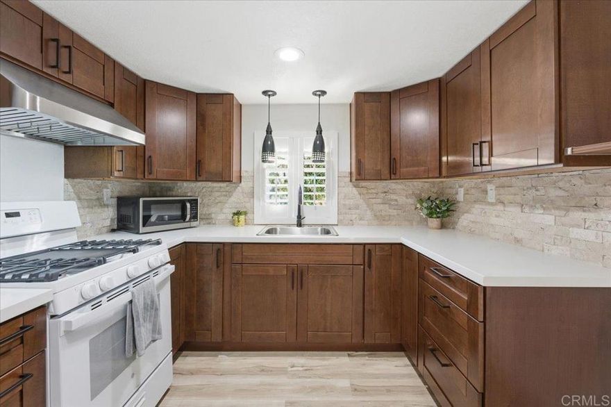 Step into this beautifully remodeled, move-in-ready gem, perfectly situated on a desirable corner lot in a peaceful senior community. This cozy, impeccably maintained home features a stylishly upgraded kitchen with natural stone accents, chic mini-pendant lighting, and a sleek stainless under-cabinet range hood. Convenience is built right in with an in-unit washer and dryer plus a handy utility sink. Elegant white interior shutters, fresh laminate flooring, and plush new carpet in the primary bedroom create a bright, inviting atmosphere throughout.  Outside, enjoy a spacious two-car carport and a charming covered patio area complete with a guava tree, lemon tree, and storage shed. The community offers resort-style amenities including a sparkling pool, clubhouse, library, and even a chapel.  This stunning home has it all—and it won’t last long!