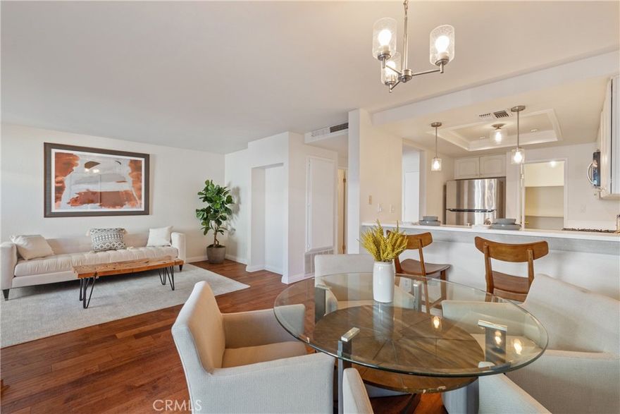 Welcome to this beautiful 2-bedroom, 2-bath townhome with a private two-car garage, ideally located in one of the quietest corners of a secure, gated, and well-kept community. Featuring a large private backyard, this property is a rare find! Step inside to a formal entry with soaring ceilings and high windows that flood the home with natural light. The open-concept layout features a spacious living room with a charming brick fireplace, a dining area, and a large kitchen with a walk-in pantry and breakfast bar, perfect for both entertaining and everyday living. Wood flooring flows through the downstairs, stairs, and upstairs hallway, while brand new carpet in the bedrooms adds comfort. Dual-pane windows enhance energy efficiency and quiet comfort. Upstairs, vaulted ceilings enhance two generously sized bedrooms. The primary suite is a true retreat, complete with a sitting area, two closets (including a walk-in), a generous en-suite bath, and a private balcony. Convenient hallway cabinets provide additional storage. Outside, your private backyard offers the perfect space for outdoor dining, gardening, or relaxing and connects directly to the attached 2-car garage with secure access, providing extra storage and convenience. Community amenities include a pool, spa, optional RV parking, and gated entry. HOA dues cover water, sewer, trash, earthquake insurance, access to all amenities, and even basic Spectrum cable and internet. Centrally located near the 405 freeway, California State University, Northridge, local parks, schools, shopping, and dining—this townhome combines comfort, privacy, and convenience.