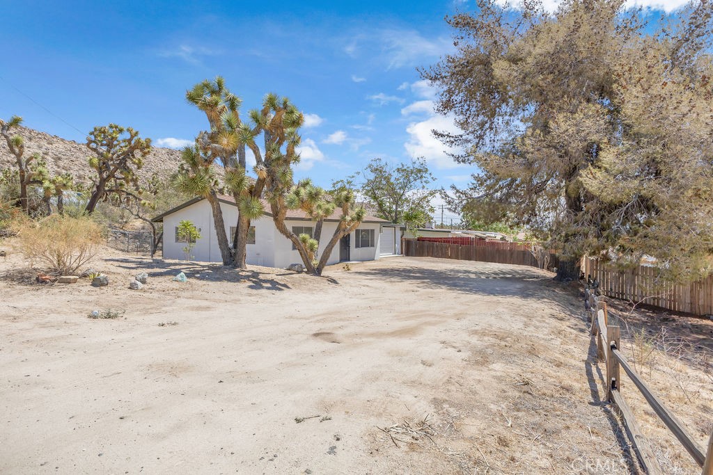 Welcome to 6879 Palm Avenue, a charming desert retreat nestled in the heart of Yucca Valley. This well-maintained 2-bedroom, 1-bathroom home offers a cozy and inviting interior with fresh paint, durable flooring, and abundant natural light throughout. The spacious living area flows seamlessly into an open kitchen featuring a gas range, ample cabinetry, and a dedicated dining nook. Both bedrooms are well-proportioned, and the updated full bathroom adds a modern touch. Step outside to a fully fenced yard with mature shade trees—perfect for relaxing, entertaining, or creating your own desert garden oasis. A storage shed offers additional space for tools and gear. Conveniently located near shopping, dining, schools, and with easy access to Joshua Tree National Park, this property is ideal as a full-time residence, weekend getaway, or income-producing rental. Move-in ready and full of potential—come see what makes this home such a smart buy in the high desert!