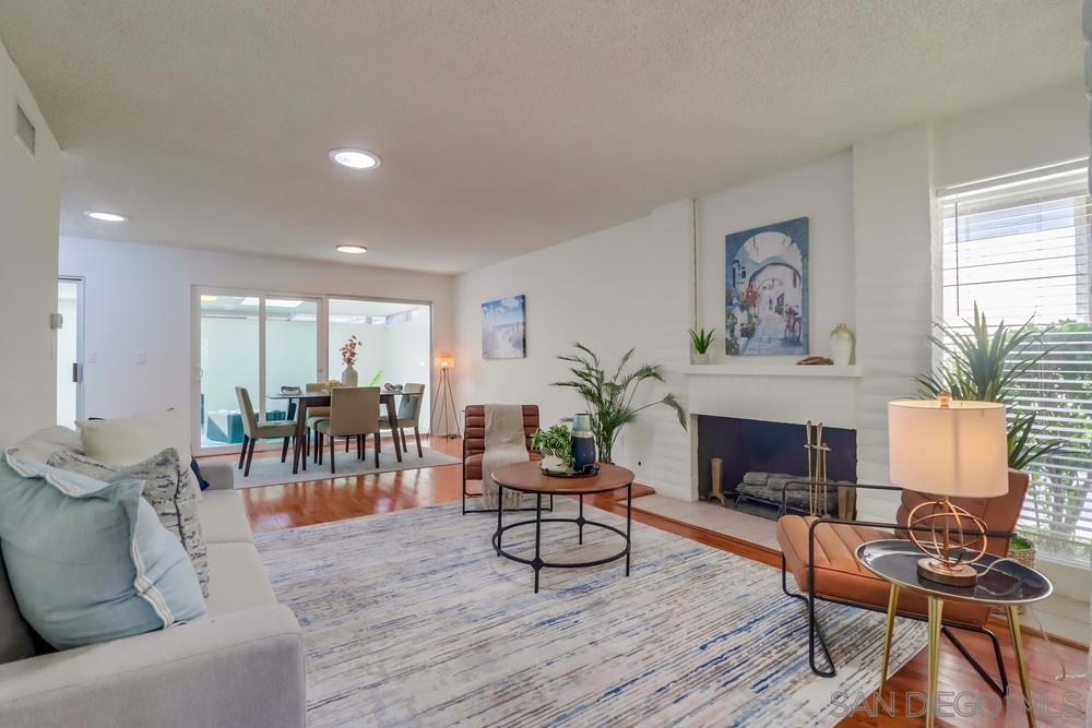 Nestled in the highly desirable Collwood Park community, this beautifully maintained 2BR/2BA single-level home offers a serene retreat. Enjoy a prime location within the development, set back from the road and overlooking one of the 3 private pools with scenic community views. The spacious & functional floor plan includes a desirable enclosed patio room, adding to the already spacious living area. The large primary master suite features pool views, double closets, a private bath, & new carpeting. The second bedroom also overlooks pool views, new carpeting, & convenient access to the full hall bathroom. The large living room, complete with a fireplace, flows seamlessly to the dining area, patio room, & kitchen. The kitchen shines with newly installed stainless-steel appliances & ample cabinet space, conveniently located just off the attached one-car garage. Additional permit parking spaces are available for residents. Sharing only one wall, this residence offers the privacy of a nearly detached home with all the benefits of condominium living. Highlights include a completely updated HVAC system, solar tube lighting, upgraded flooring, fresh paint, beautiful mid-century modern wood cabinets, & abundant storage. Enjoy the convenience of a private washer/dryer in the garage & a newer water heater. Collwood Park, a low-density community spanning 26 acres, offers 3 large pools (one heated year-round), two spas, a clubhouse, walking paths, & lush landscaping. This property's central location provides easy access to SDSU, freeways, shopping, dining, & the beaches.