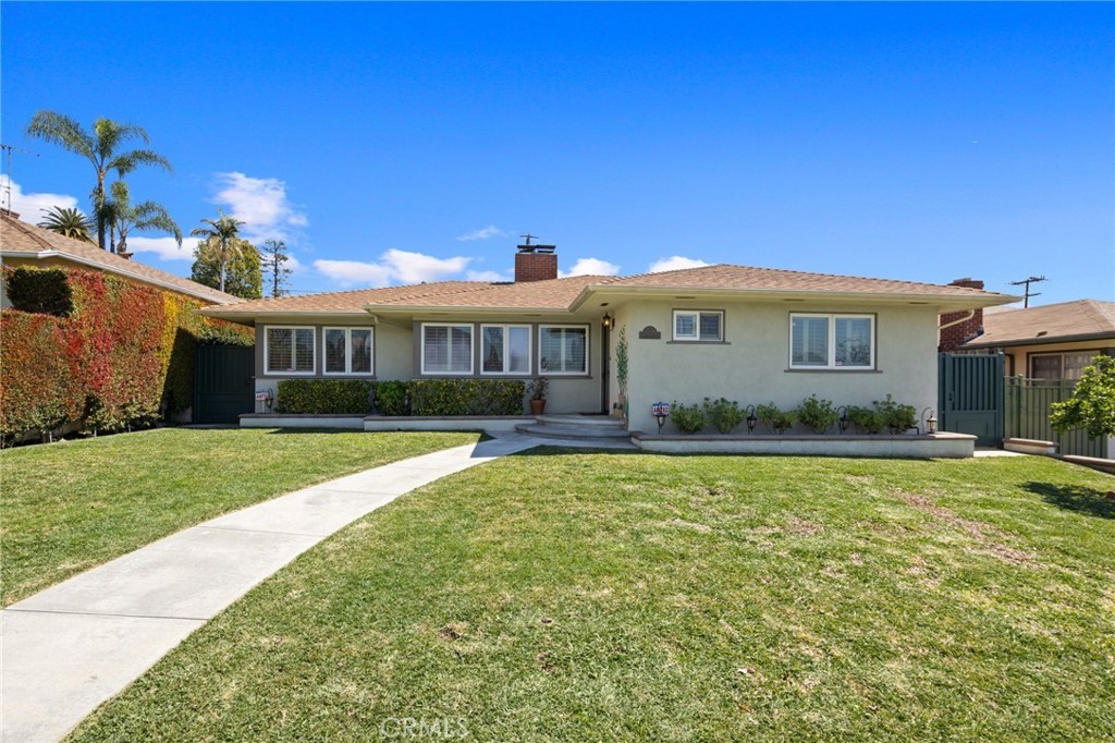Located in desirable north Monrovia, this tastefully updated home beams with pride of ownership and sophistication. Nearly every inch of this meticulously maintained home has been reimagined and designed with care. Stepping into the main open-concept living & dining space, you’re greeted by the inviting fireplace and gleaming hardwood floors that run through the entirety of the home. Attention to detail can be found everywhere you look, including fresh paint, custom crown moldings and millwork throughout, and plantation shutters that frame every window of the home. No expense was spared as this home has been loved and cared for. Enjoy the chef’s kitchen featuring custom cabinetry, under cabinet lighting, Thermador & GE appliances, and access to the laundry room and half bath. Just off the kitchen, you’ll find the separate family room space featuring a second brick-faced fireplace and a wall of sliding doors that open to the backyard. In the south wing of the home, the primary bedroom suite includes a spa-like bathroom and generously-sized wall closet with custom organizer. Down the hall you’ll find the large junior bedroom complete with its own wall closet, and an impressive shared hallway bath with both a walk-in shower and soaking tub. With gorgeous mountain views to the north, the outside of the home shows just as well as the inside. Accented by refined landscaping and hardscape, both the front and rear yards feature outdoor lighting with automatic timers, full sprinkler system and custom wrought iron security gates. Enjoy the rear patio with custom electronic awnings overhead that allow for year-round outdoor entertaining and gatherings, a generous grass area, and privacy hedge that surrounds the entire rear of the property. The rear yard also provides entry to a convenient bonus room that could be used as a private third bedroom, office, gym, game room, or creative space. Just beyond the grass area is the oversized driveway that allows for ample parking with alley access via electric gate. Adjacent is the finished garage, complete with built-in cabinetry and custom pebble epoxy floor coating. This turnkey property is a true gem, full of enticing modern amenities and upgrades, while maintaining the charm that the Monrovia foothills has to offer.
