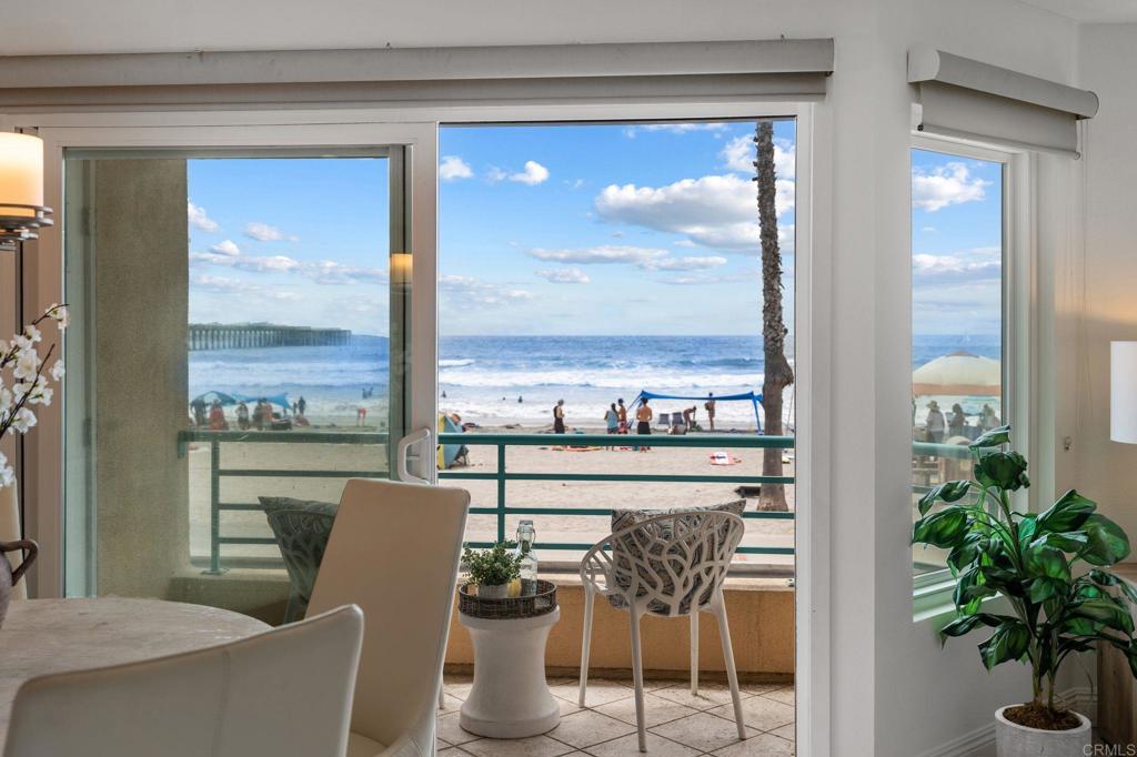 Experience breathtaking front-row coastal living at 400 N The Strand #27—a beachfront gem in the coveted San Miguel III community. This rare ground-level unit offers no-stairs access, making beachside living both luxurious and effortless. Enjoy panoramic white water ocean views and the soothing sound of waves from the comfort of home! Inside, the condo features fresh paint and tastefully updated bathrooms, creating a clean and modern coastal vibe. The open-concept living space is filled with natural light and opens directly onto an ocean-view patio—perfect for dining al fresco or soaking in the sunsets over the Pacific. As evening falls, take in the magical sight of the Oceanside Pier glowing against the night sky—an unforgettable view right from your living room or patio. The spacious primary bedroom features a walk-in closet and dual sink vanity. Additional highlights include in-unit laundry, a cozy fireplace, and two assigned underground parking spaces in a gated garage with elevator access. Ideally located just a short stroll from the Oceanside Pier, marina, and vibrant downtown, this home puts you steps away from Oceanside’s best dining, coffee shops, and boutique shopping. San Miguel III is a well-maintained beachfront community featuring two spas, beautifully landscaped grounds, and multiple access points to the sand. Whether you're looking for a peaceful beachfront escape or an unbeatable location to enjoy all that Oceanside has to offer, this is your chance to own a front-row seat to Southern California’s iconic coastline.