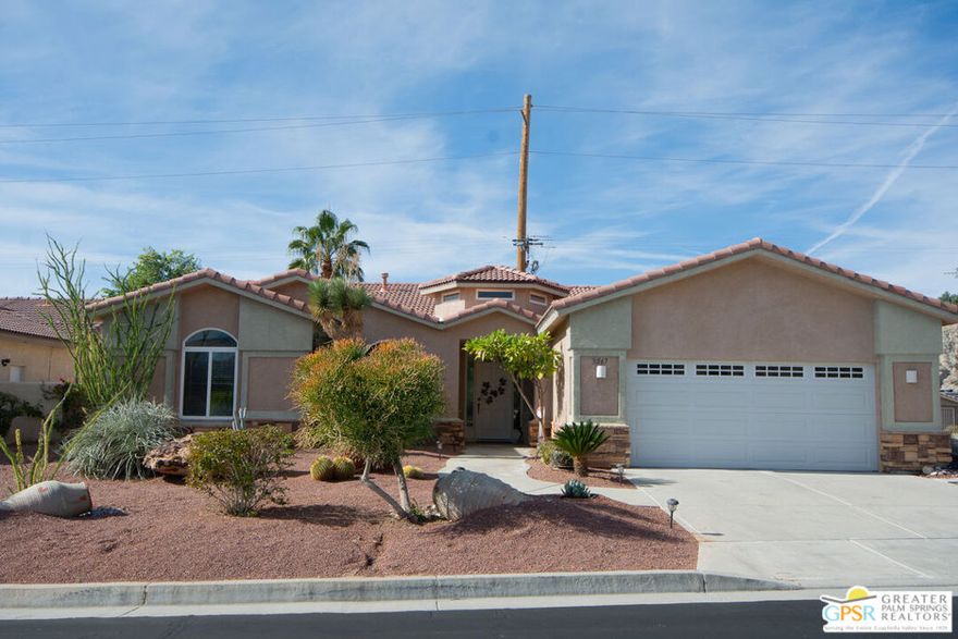 Welcome to 8567 Summit Pass, perfectly positioned on a premium elevated lot within the highly sought-after 55+ gated community of Paradise Springs. This former model home features 2 bedrooms plus a spacious office/den that offers an easy conversion to a true third bedroom, along with 3 baths across 2,338 sqft of bright, inviting living space. The open-concept layout showcases high ceilings, a cozy fireplace flanked by custom built-ins, and a thoughtfully designed kitchen complete with solid-surface countertops, decorative tile accents, and a welcoming breakfast bar. A reverse osmosis water filtration system provides clean, filtered water throughout the home. Indoor living flows seamlessly into the private backyard retreat, where you'll find flagstone hardscaping, a covered patio, and a built-in BBQ ideal for both entertaining and quiet evenings under the desert sky. Enjoy stunning west-facing views of city lights and Mt. San Jacinto, creating a picturesque backdrop year-round. The primary suite opens directly to the backyard and offers a spacious bath and generous walk-in closet, delivering comfort and convenience. Paradise Springs elevates desert living with resort-style amenities, including a clubhouse, fitness center, pool and spas, BBQ/picnic areas, and secure gated access. Residents also benefit from being adjacent to Mission Lakes Country Club, featuring an acclaimed 18-hole championship golf course. With low HOA dues of just $148 per month, this home offers an exceptional blend of comfort, quality, and lifestyle. Schedule your private showing today - opportunities like this are rare.