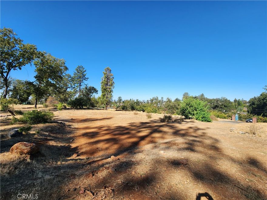 Beautiful 1.90 acres of level, fully fenced land in Lower Paradise with privacy, open views, and a peaceful setting just 11 minutes to Chico. Property features a large entry gate, fruit trees, and plenty of space for gardening, 4-H animals, or simply enjoying the outdoors. Deer and wild turkeys often wander through, adding to the natural charm. Unlike many lots in Paradise, the seller has continued paying PID water fees, so water service is active and only a meter installation is needed—saving the buyer $5,000–$6,000 in reconnection costs. With no neighbors behind, the parcel backs to large acreage owned by a cemetery, ensuring lasting privacy. The location offers the best of both worlds—close to town yet tucked in a country setting where the night skies are dark and full of stars, making the property beautiful both day and night.