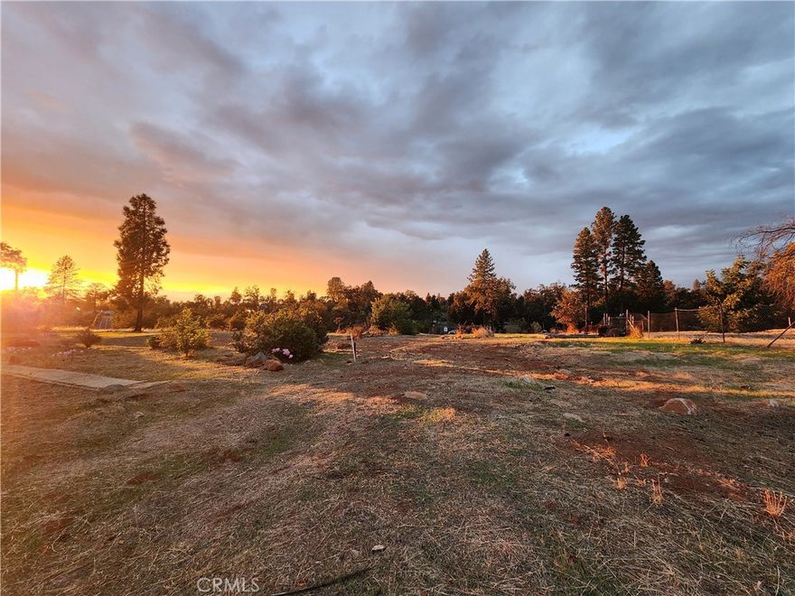 Beautiful 1.90 acres of level, fully fenced land in Lower Paradise with privacy, open views, and a peaceful setting just 11 minutes to Chico. Property features a large entry gate, fruit trees, and plenty of space for gardening, 4-H animals, or simply enjoying the outdoors. Deer and wild turkeys often wander through, adding to the natural charm. Unlike many lots in Paradise, the seller has continued paying PID water fees, so water service is active and only a meter installation is needed—saving the buyer $5,000–$6,000 in reconnection costs. With no neighbors behind, the parcel backs to large acreage owned by a cemetery, ensuring lasting privacy. The location offers the best of both worlds—close to town yet tucked in a country setting where the night skies are dark and full of stars, making the property beautiful both day and night.